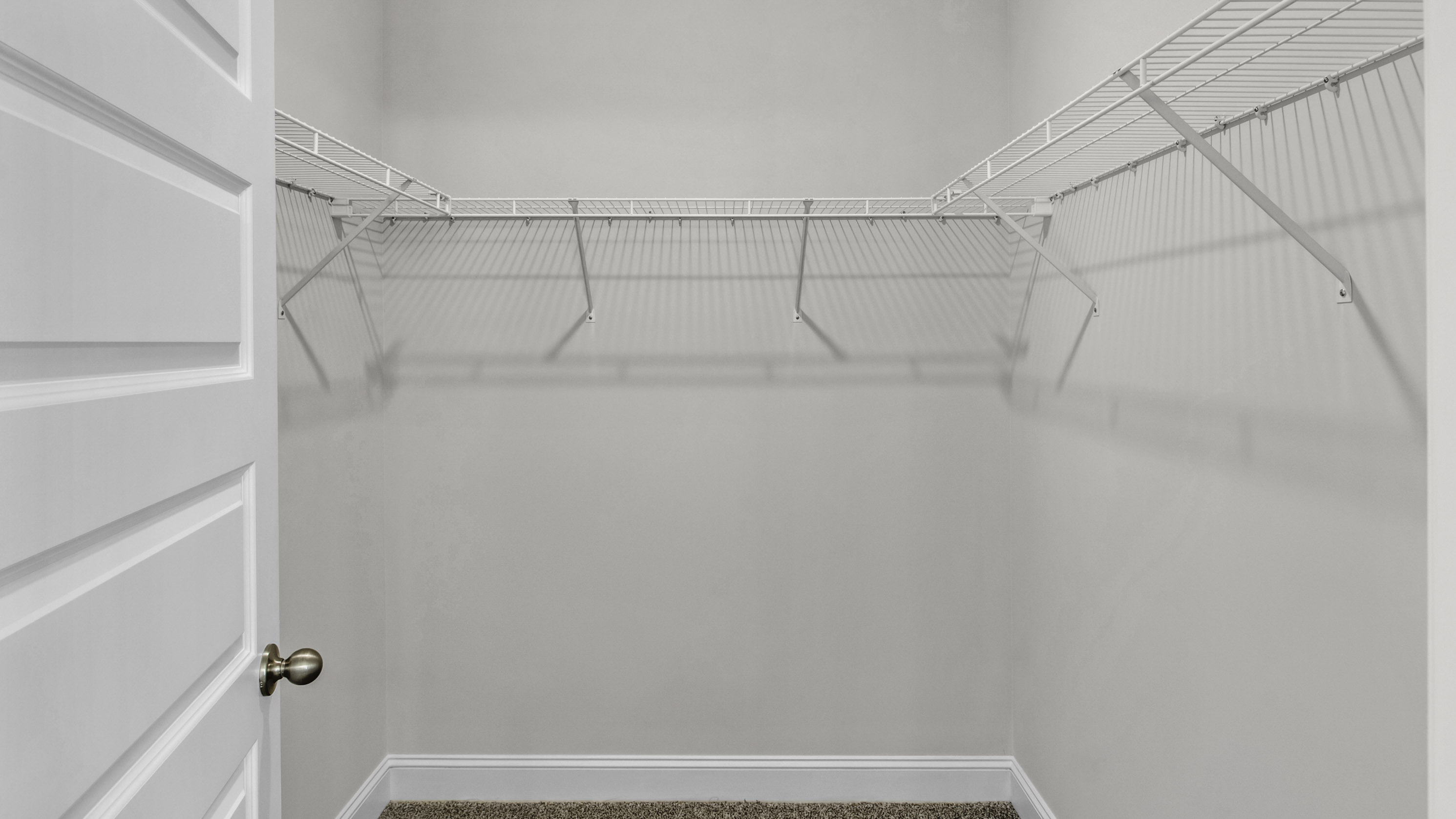 Spacious primary closet with ventilated shelving