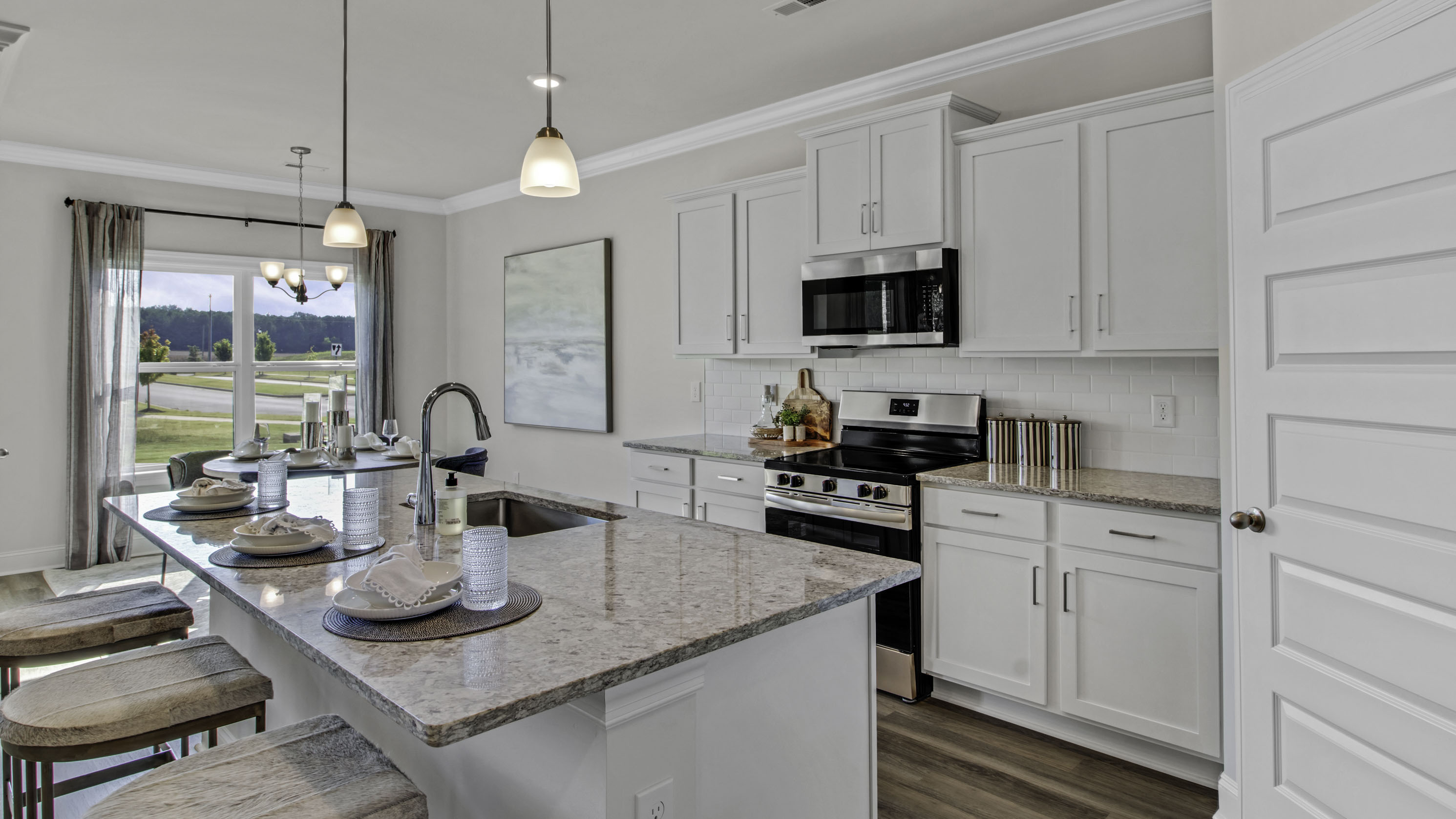 Beautiful kitchen opens up at the long entry hall