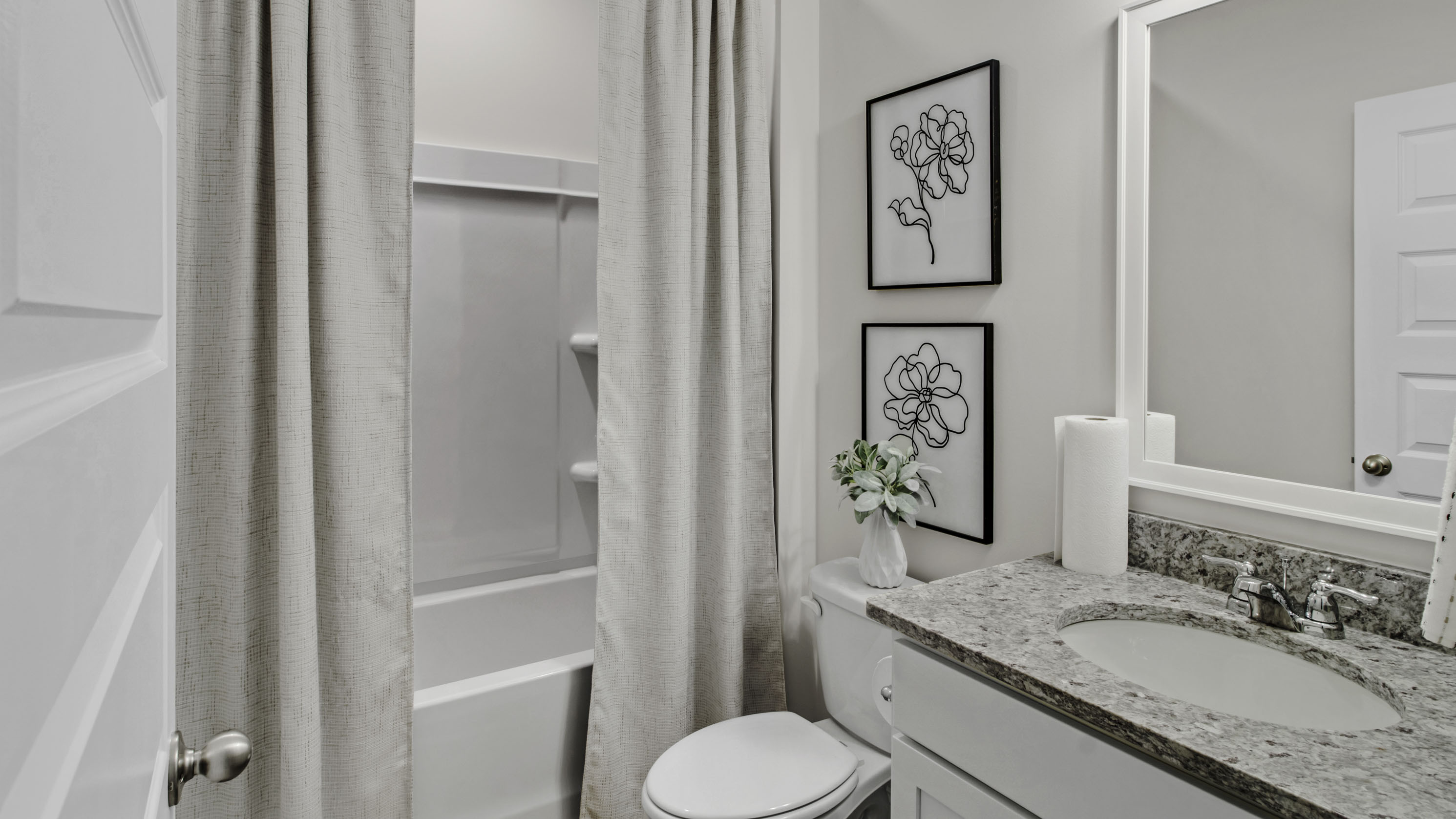 Third bathroom with a single vanity and an acrylic tub/shower insert