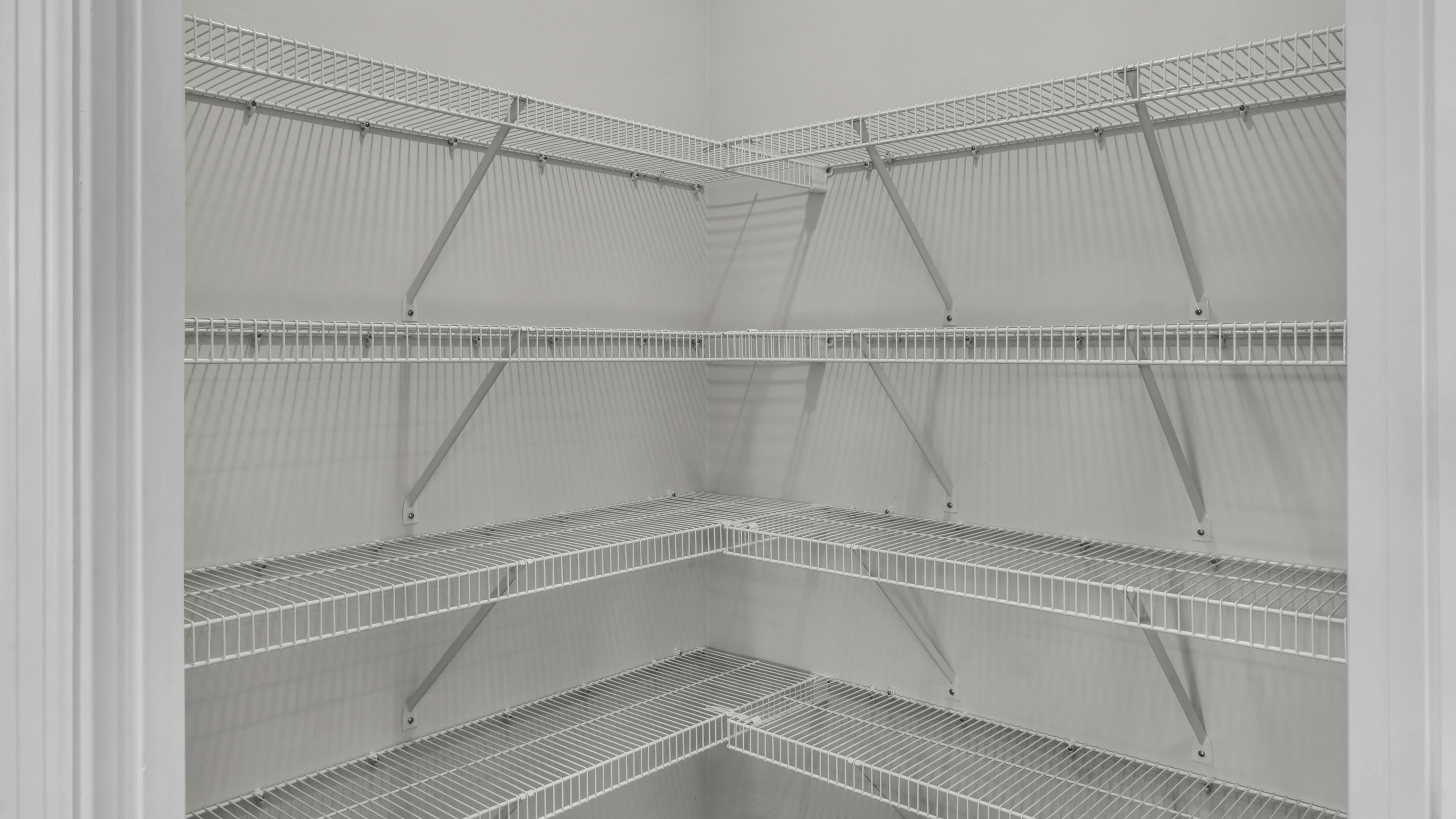 Pantry closet is spacious with ventilated shelving