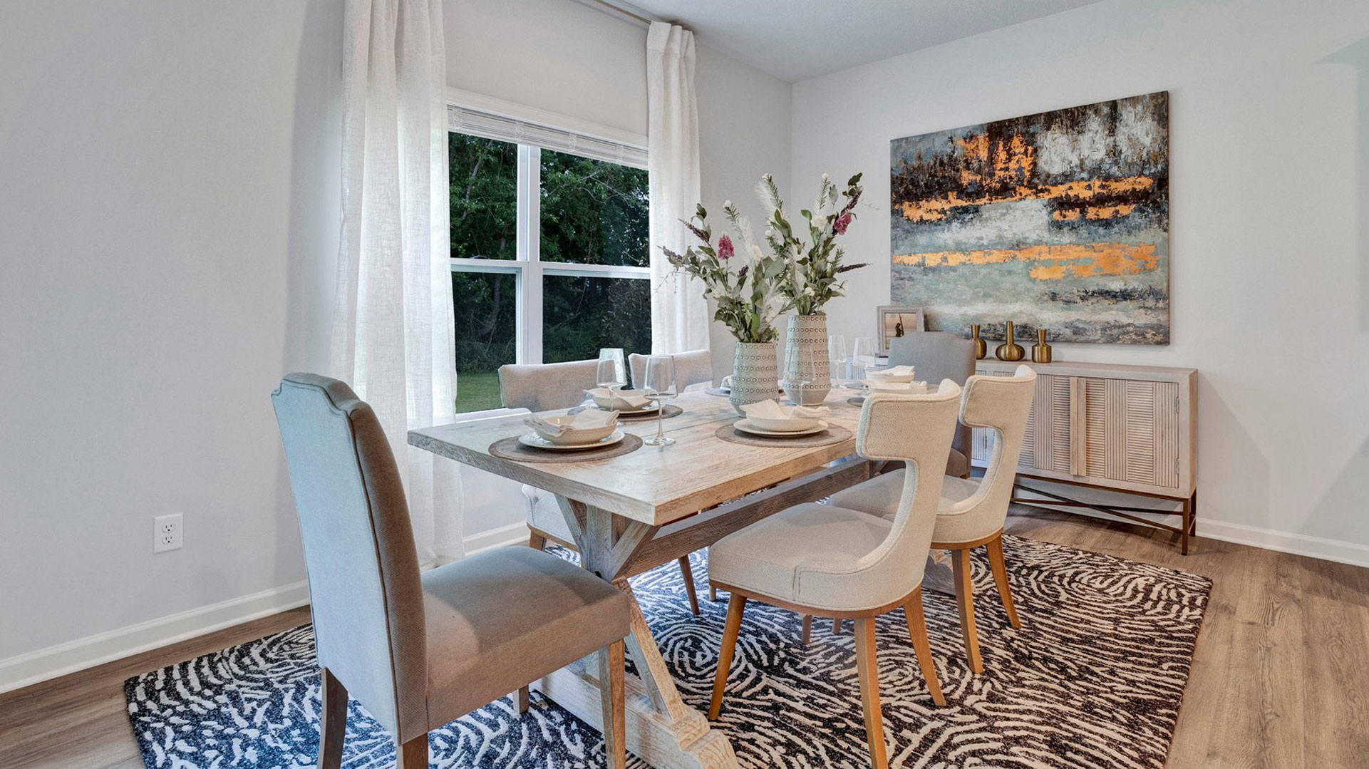 Dining room with a large double window overlooking the backyard