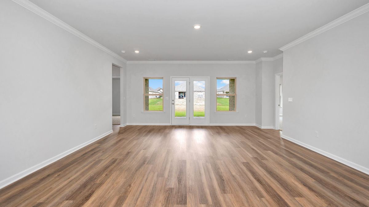 Beautiful living room spacious with tall windows overlooking the backyard