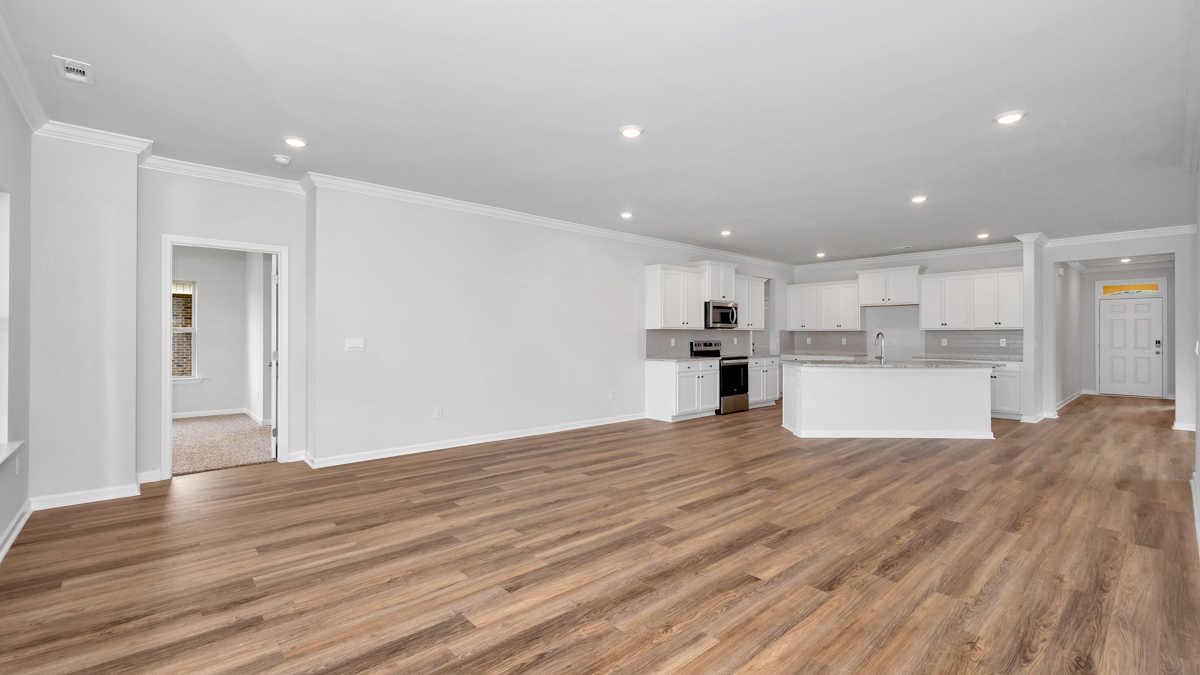 Open concept view of the kitchen overlooking the living and dining room