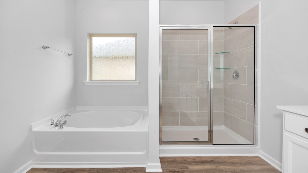 EN suite with a walk in shower and tub
