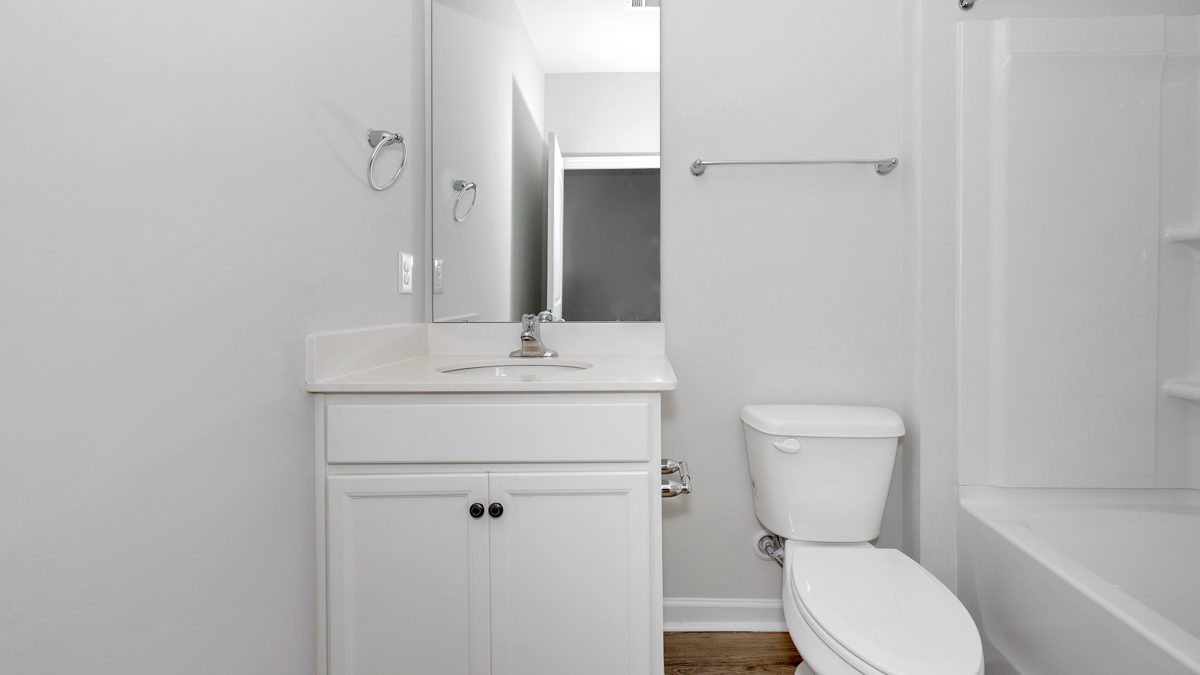 Guest bathroom in bedroom with a single vanity and an acrylic tub/shower insert