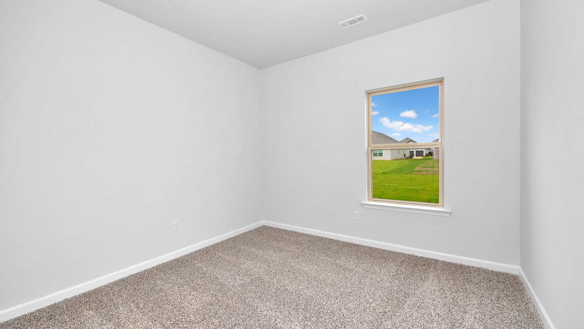 Second bedroom with carpet flooring and neutral paint