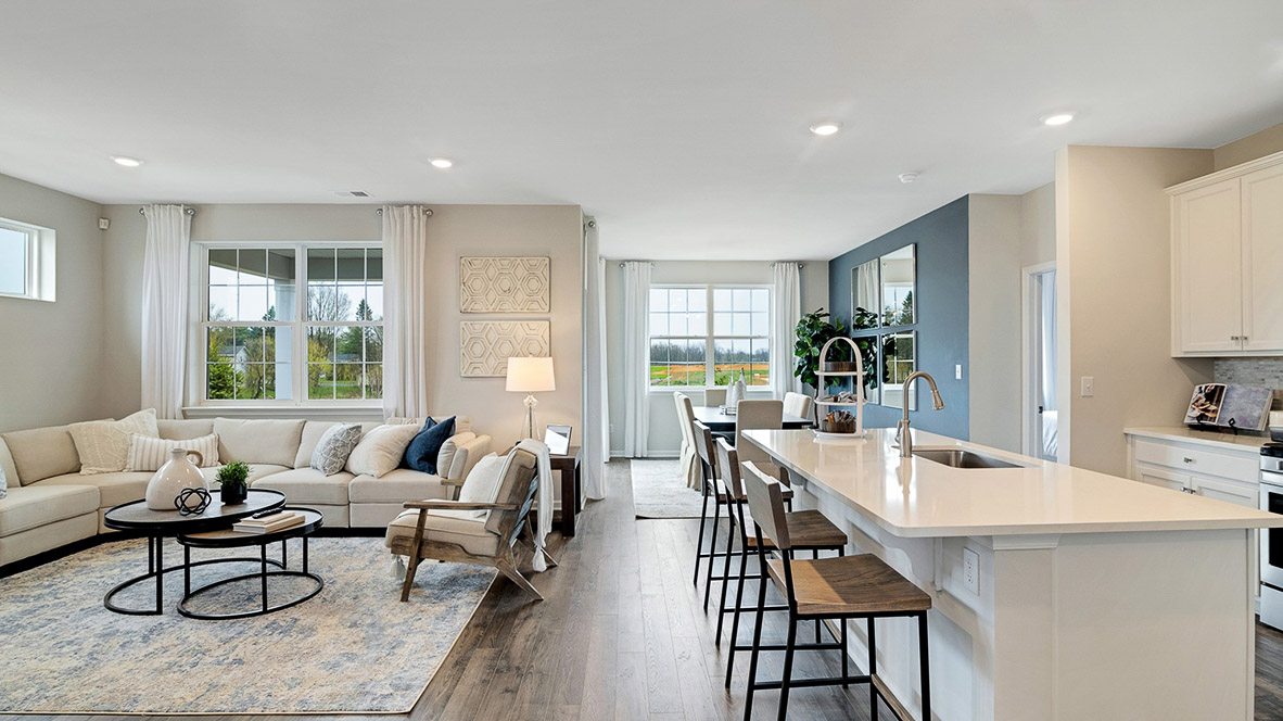 Open concept of the main living area that open up at the end of entry hall