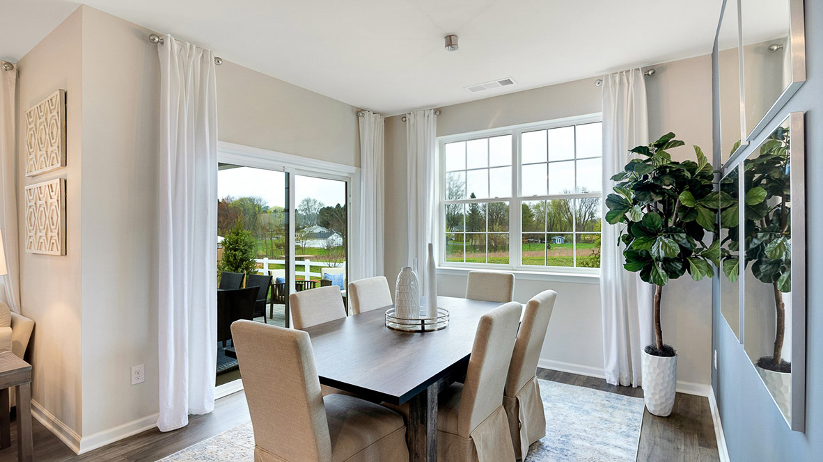 Dining area with double window overlooking the backyard