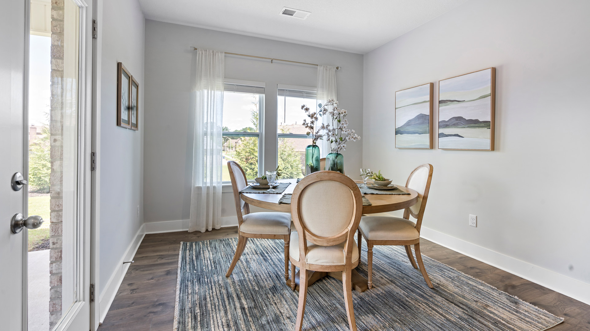 Dining room area with a double window overlooking the backyard