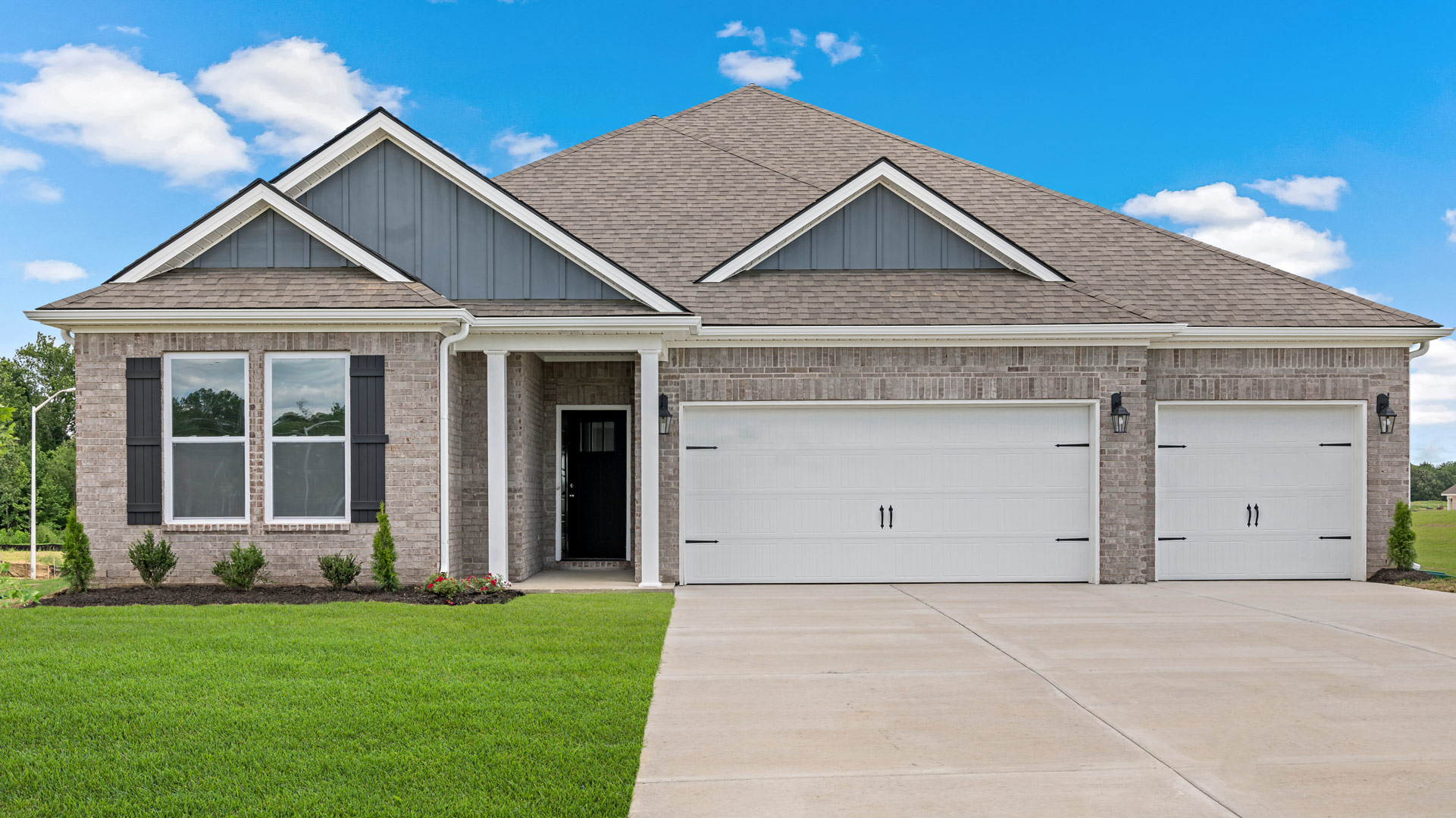 Exterior elevation of the Covington floorplan, a single sotry home with a 3 car garage