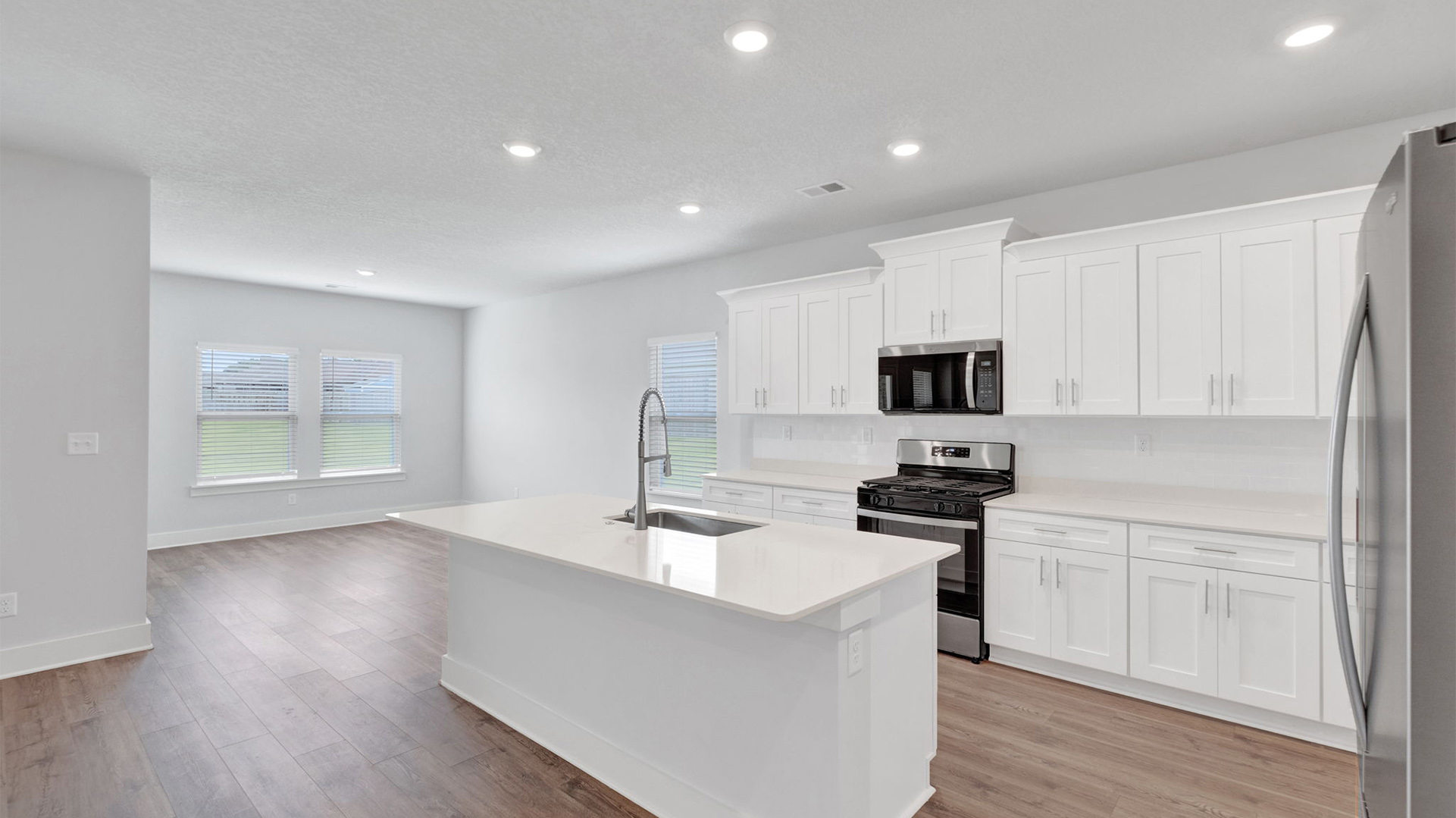 Kitchen area with quartz countertops and light cabinets