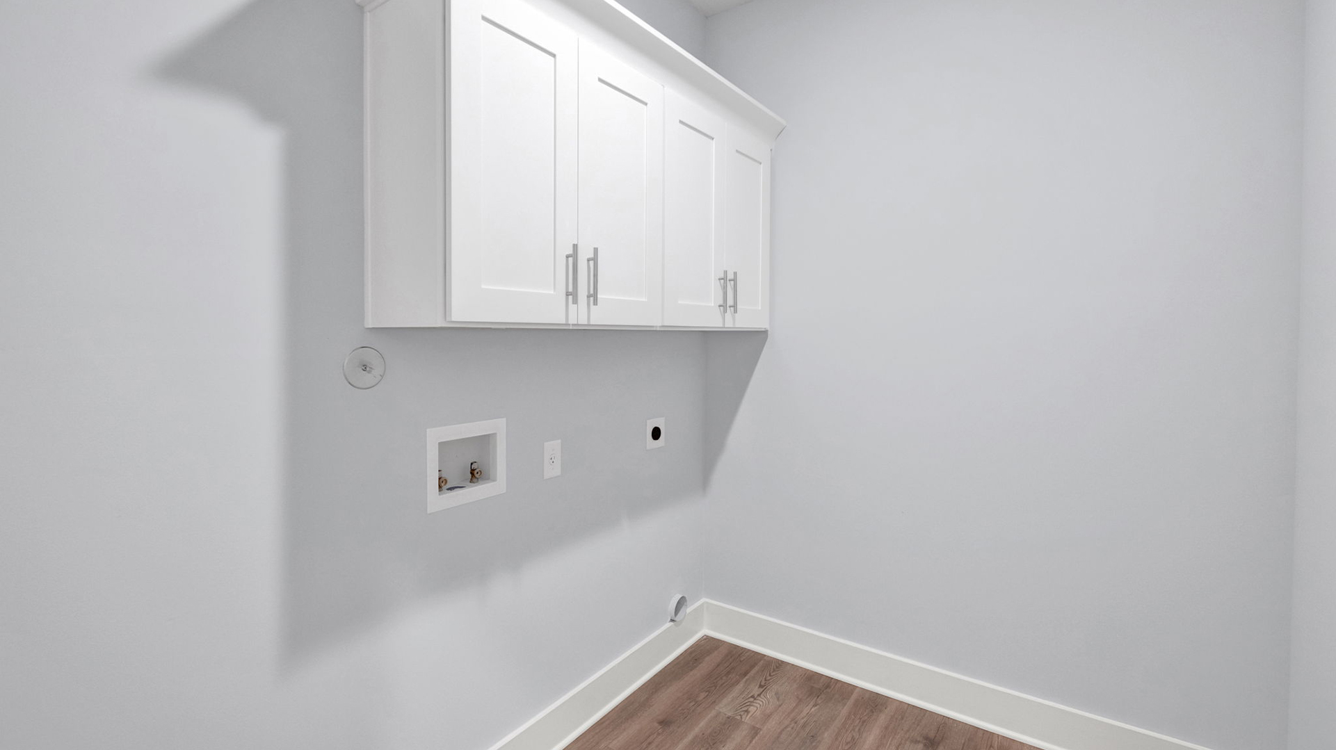 Laundry room with custom shelving and vinyl flooring