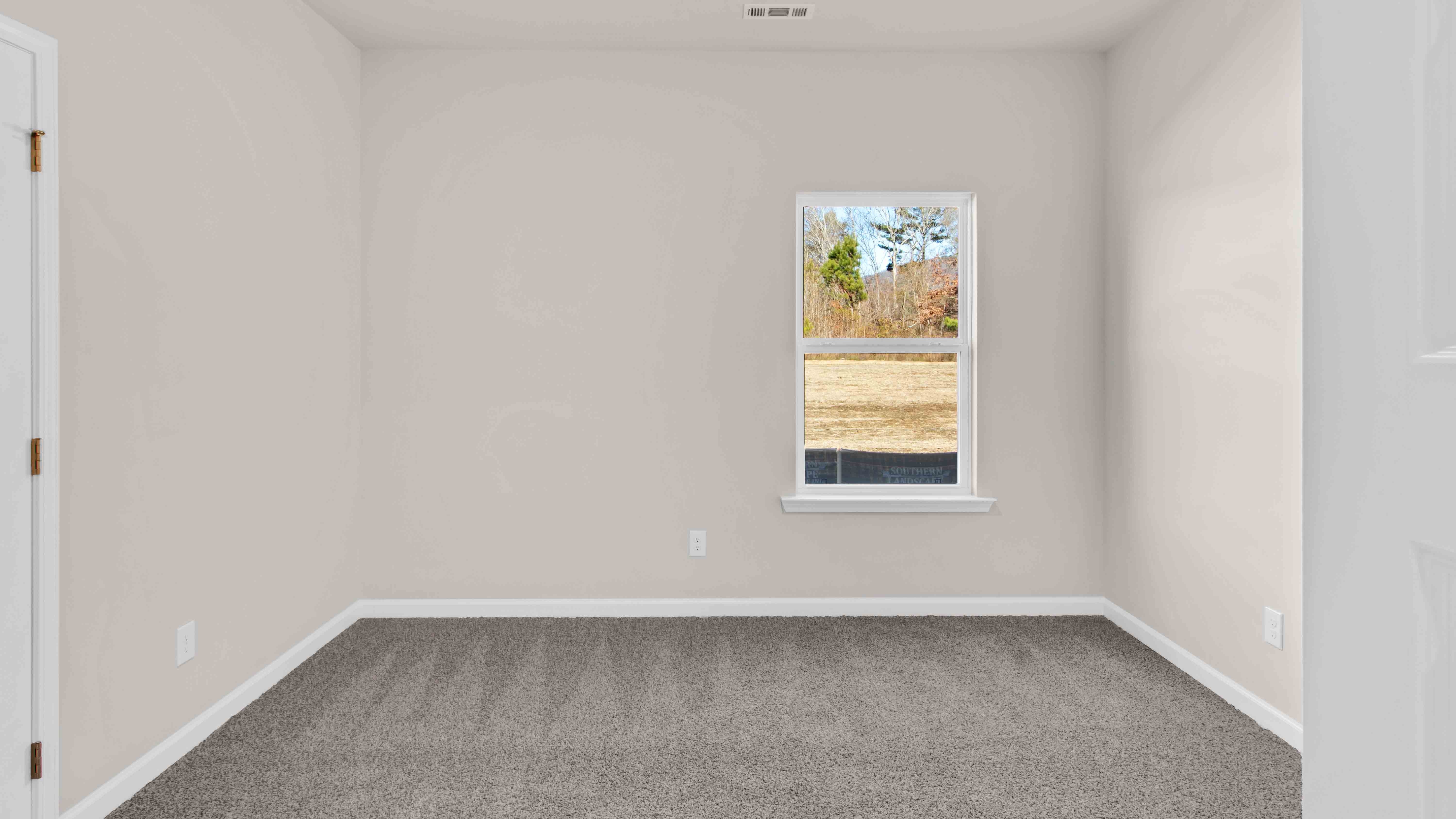 Fourth bedroom with carpet flooring and neutral paint