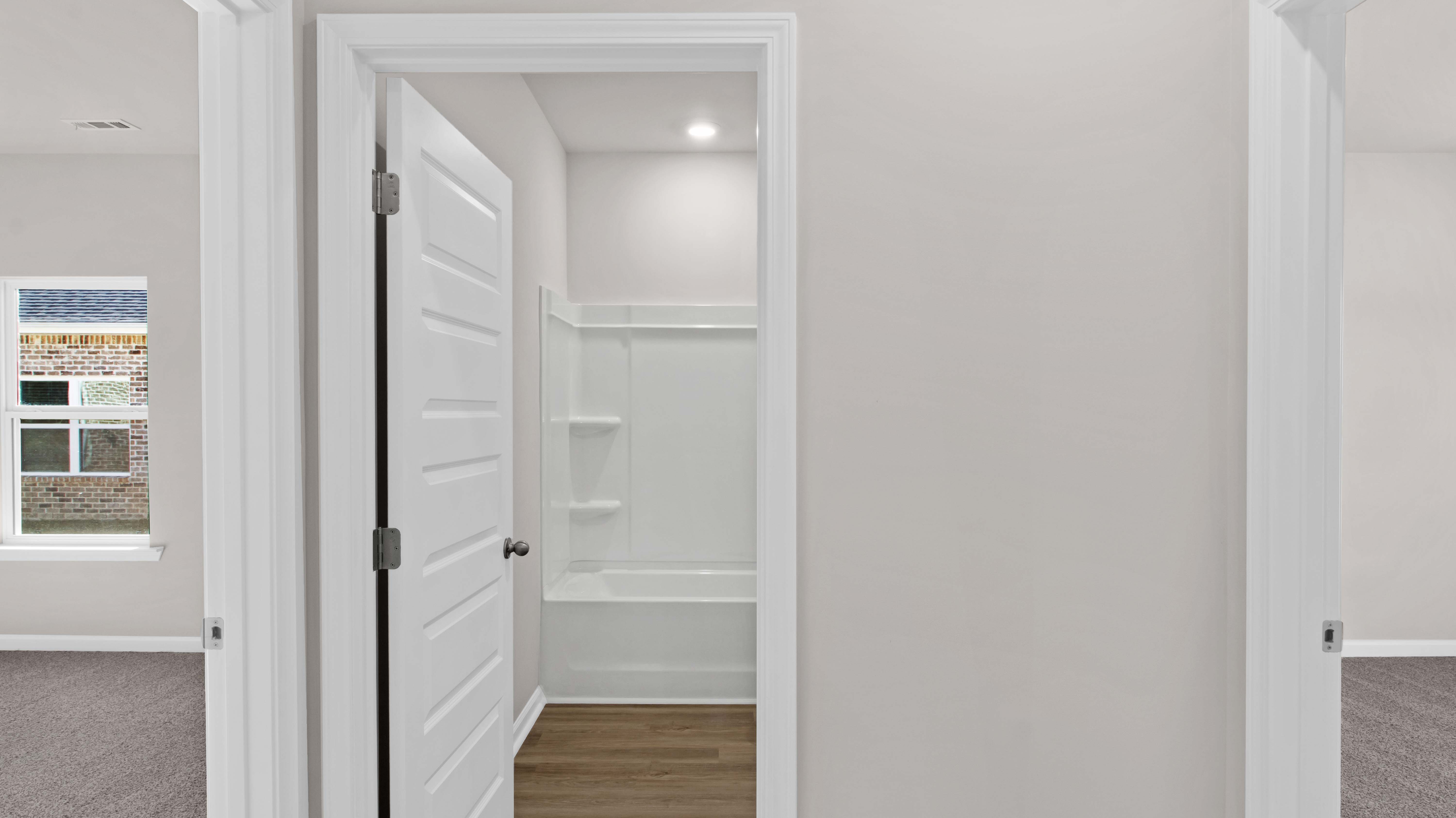 Entry foyer leading into the guest bathroom