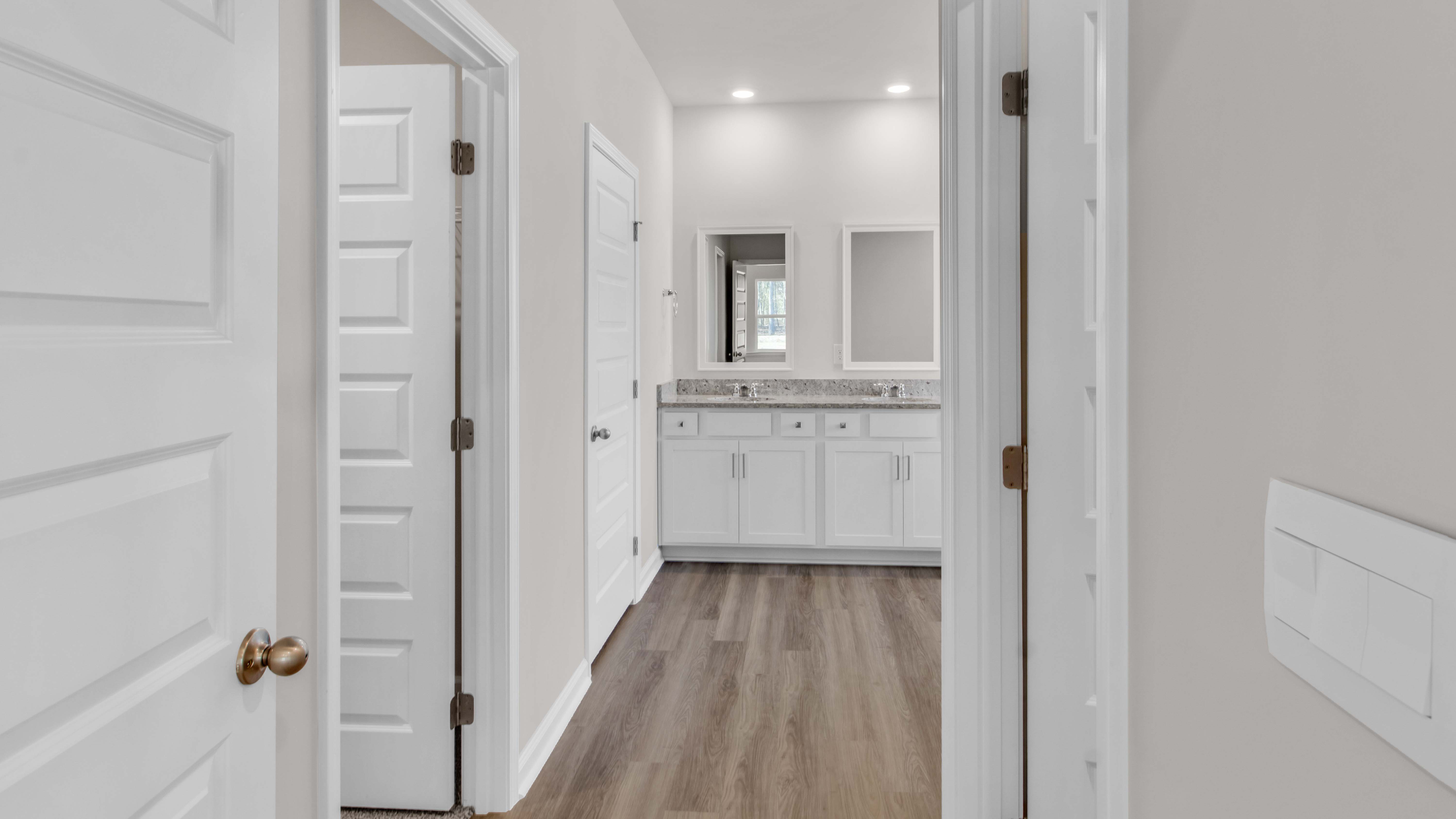 En suite primary bathroom with a french door entry