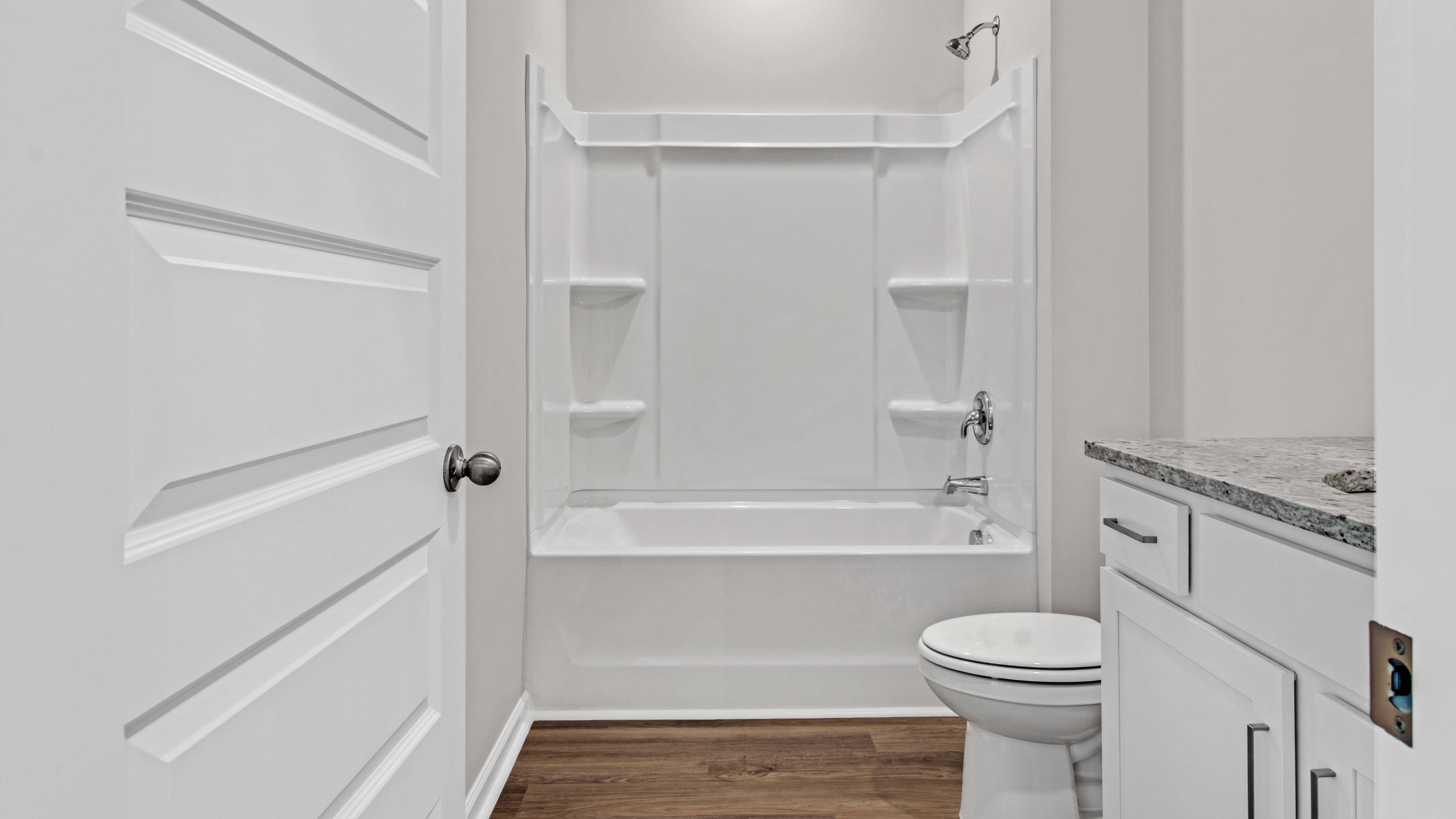 Guest bathroom with a single vanity and an acrylic tub/shower insert