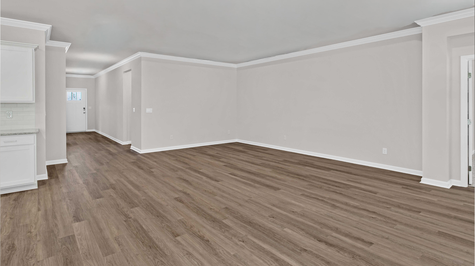 Living room with vinyl flooring and neutral paint