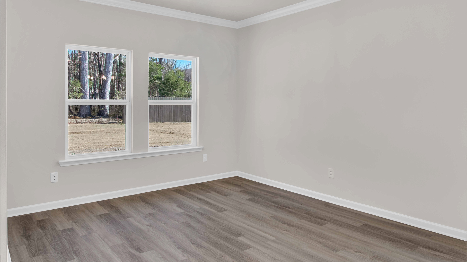 DIning room with a large double window overlooking the backyard