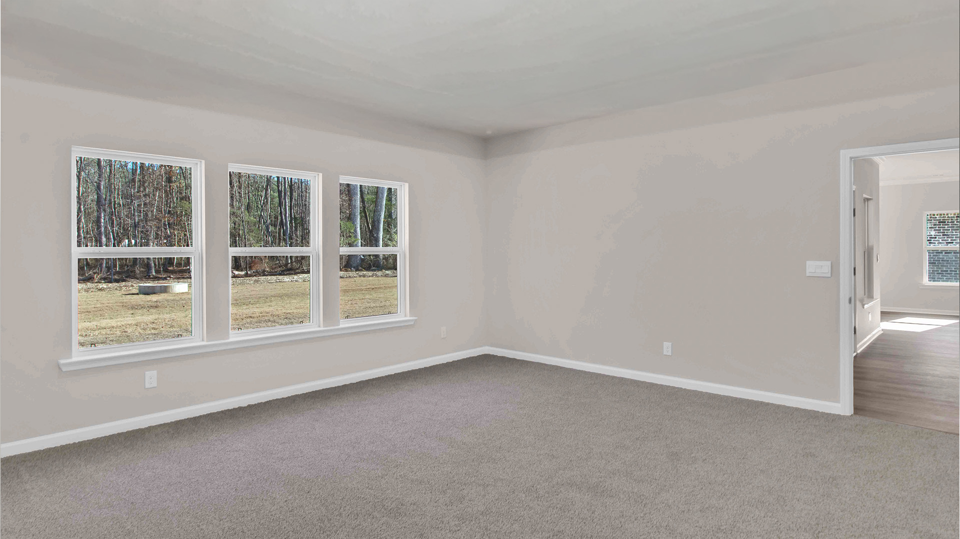 Primary bedroom with beautiful tall windows overlooking the backyard