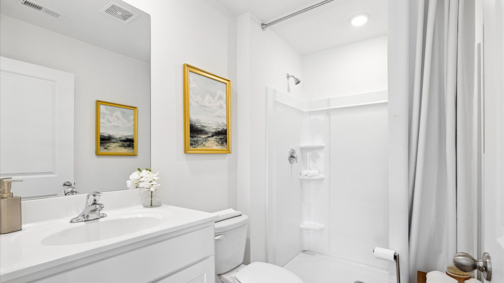 Second bathroom with a single vanity and acrylic tub/shower insert