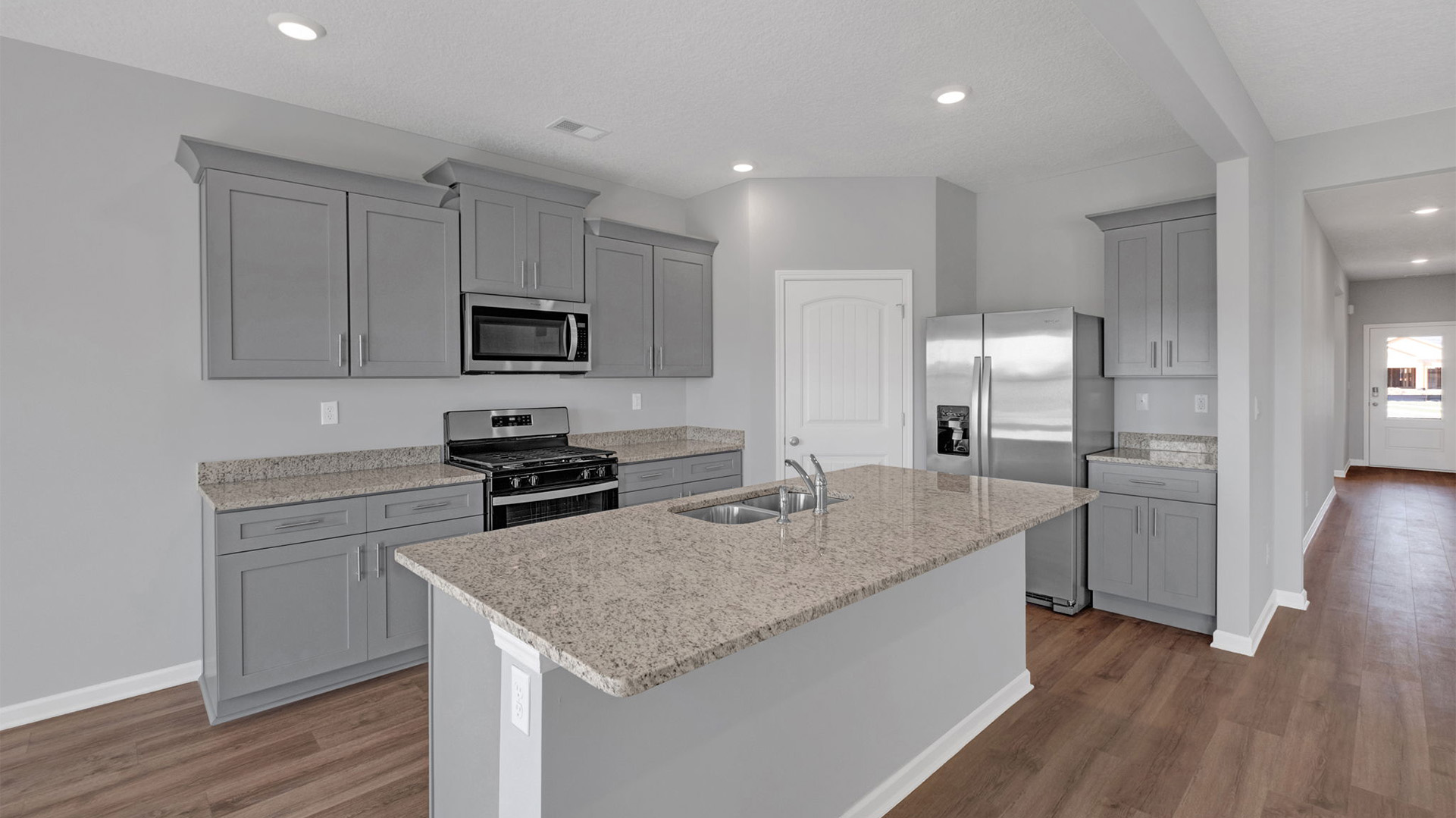Beautiful kitchen area opens up at the end of entry hall
