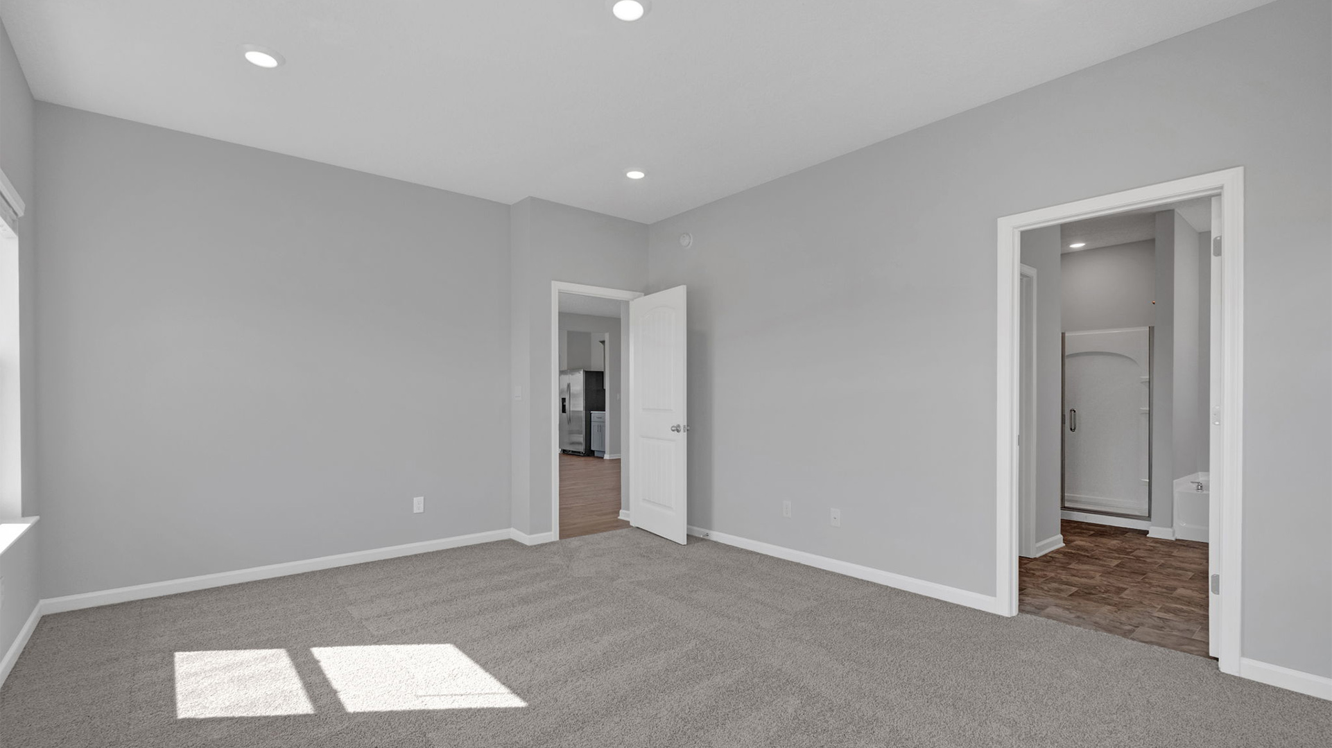 Primary bedroom with carpet flooring and neutral paint