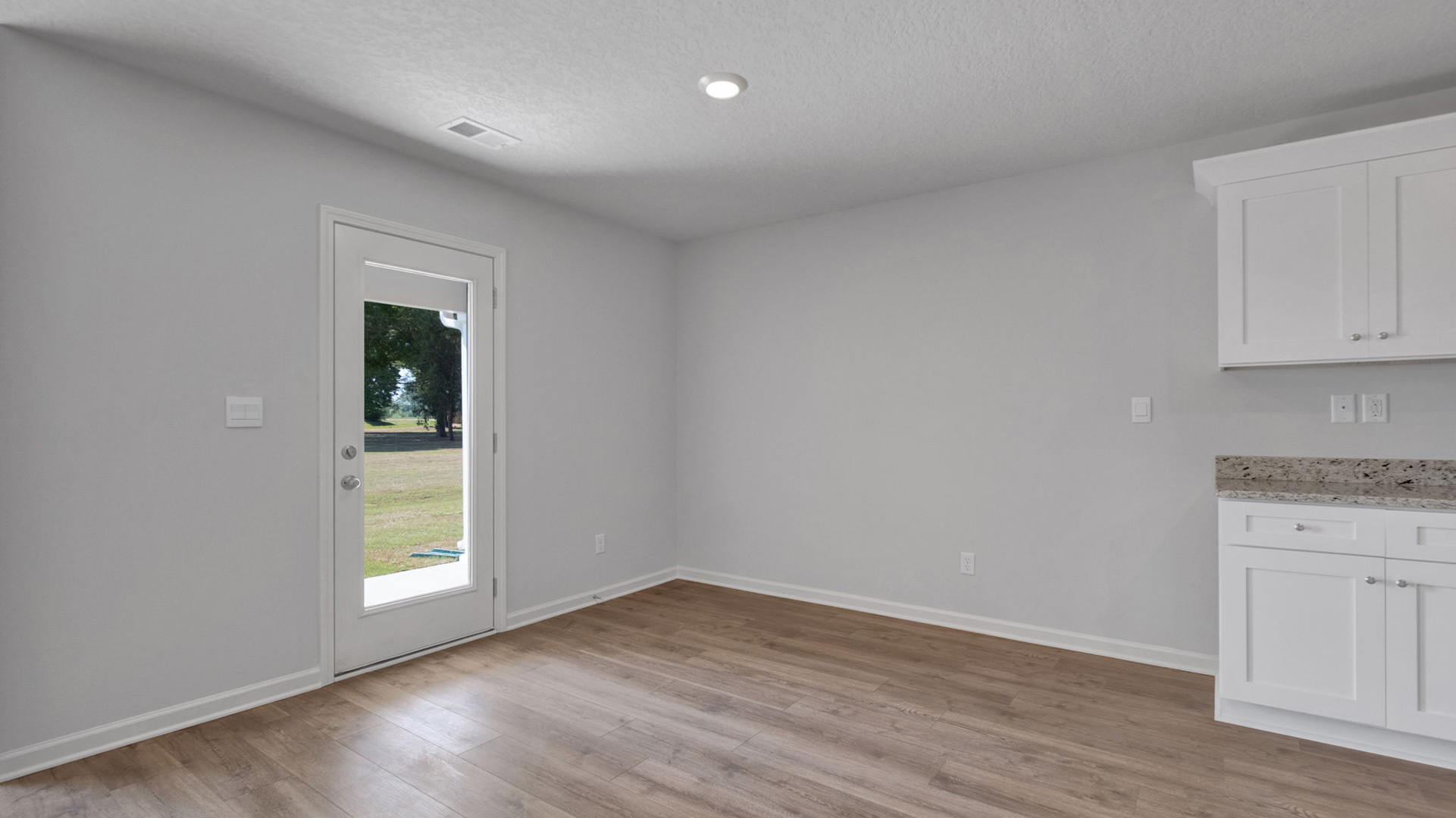 Dining room with vinyl flooring and neutral paint
