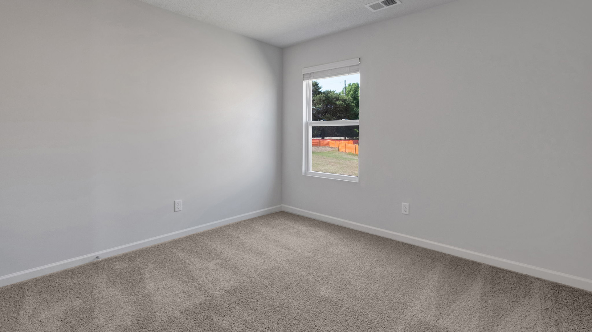 Third bedroom with carpet flooring and neutral paint