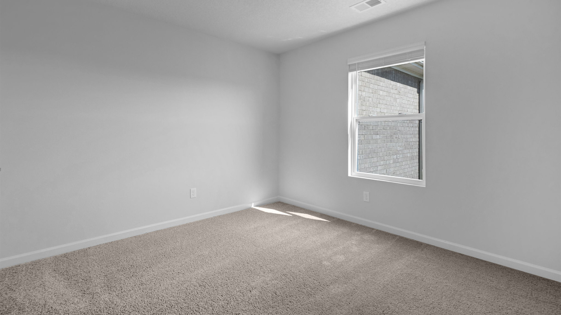 Fourth bedroom with carpet flooring and neutral paint