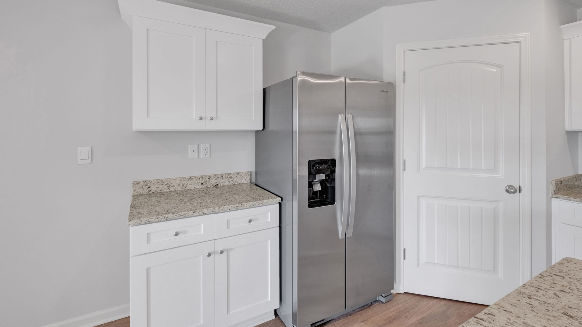 Kitchen pantry is located in the corner right next to the fridge
