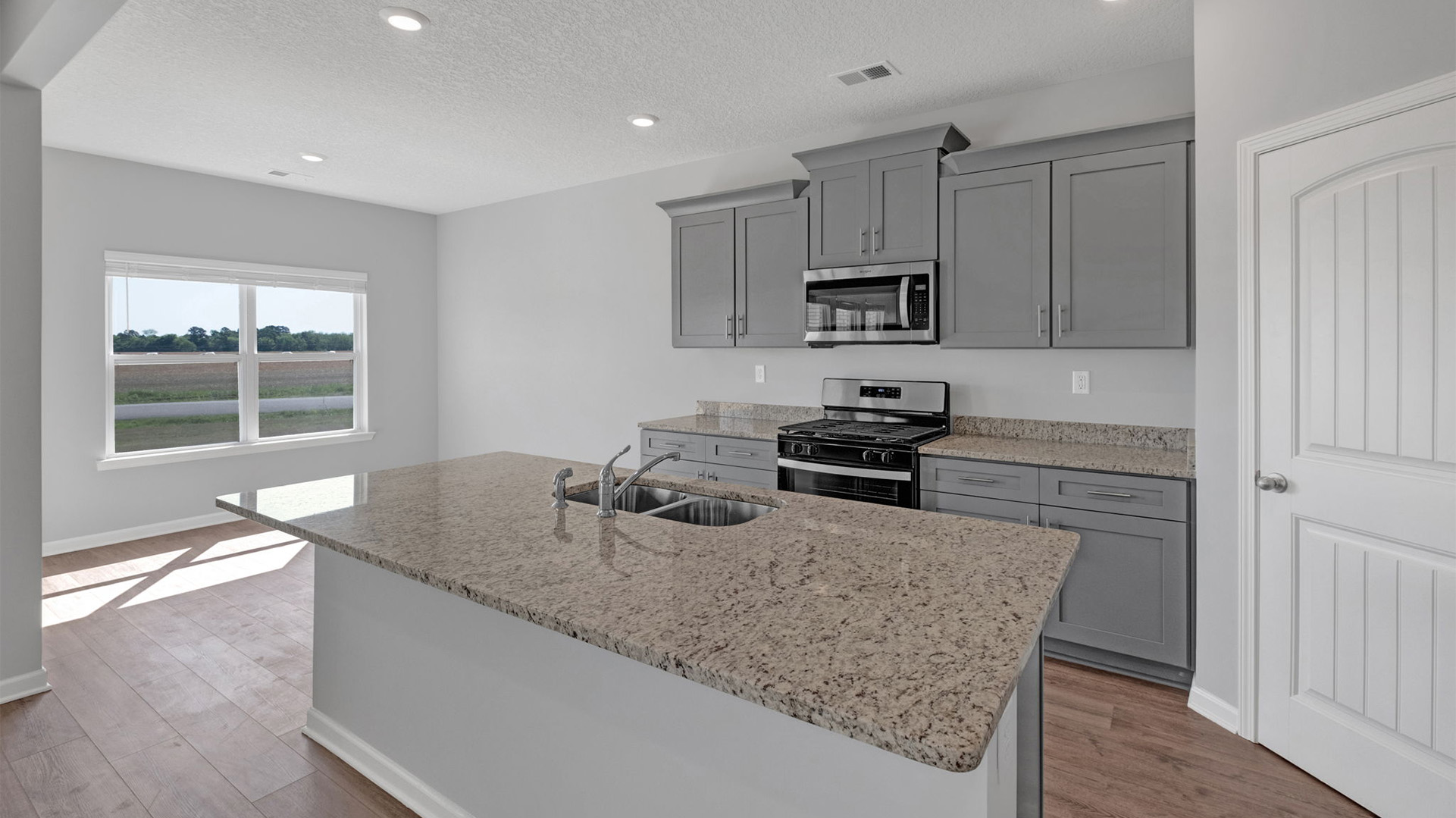 Beautiful kitchen with light cabinets and stainless steel appliances