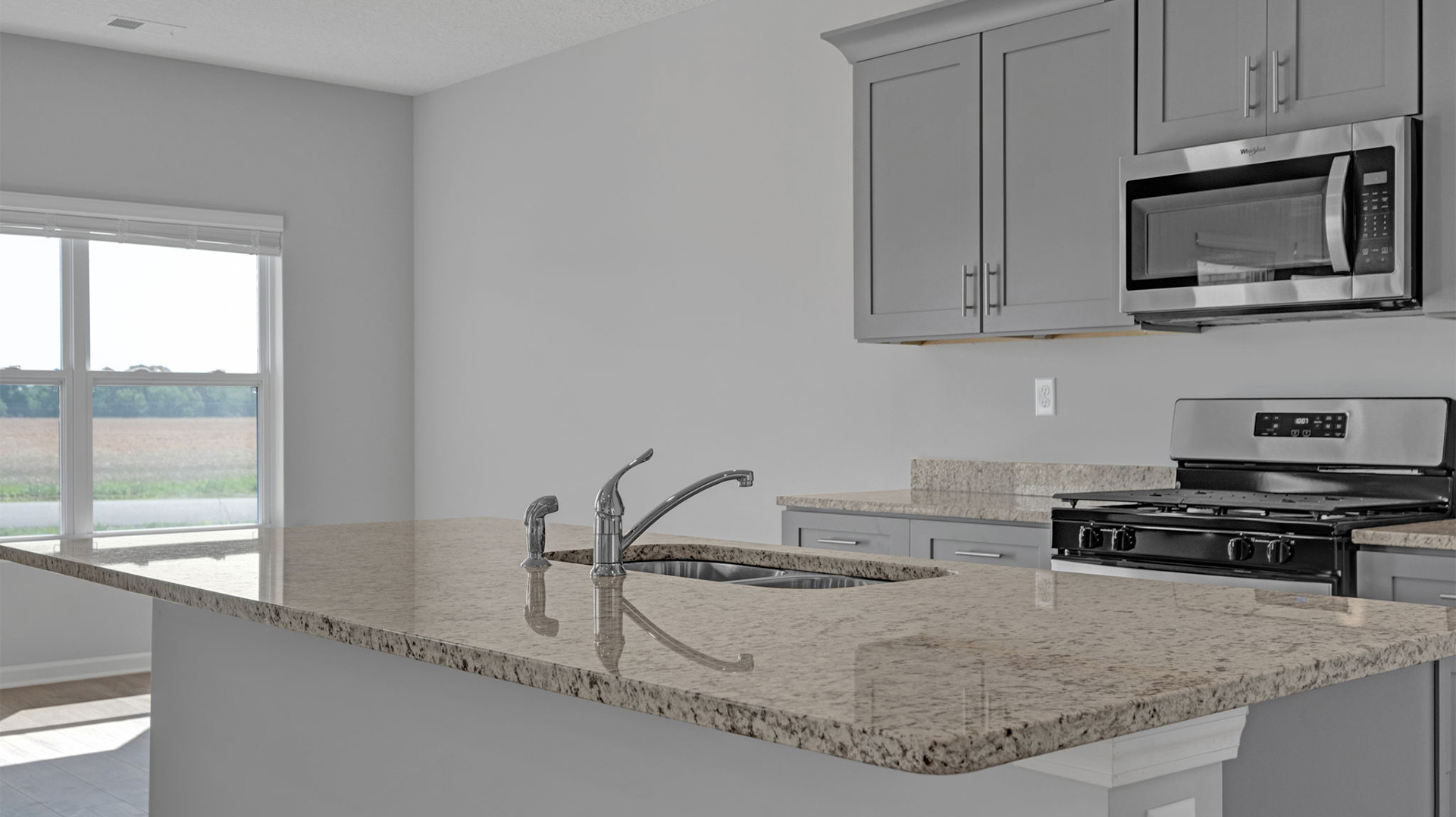 Beautiful goose neck kitchen faucet over the stainless steel sink