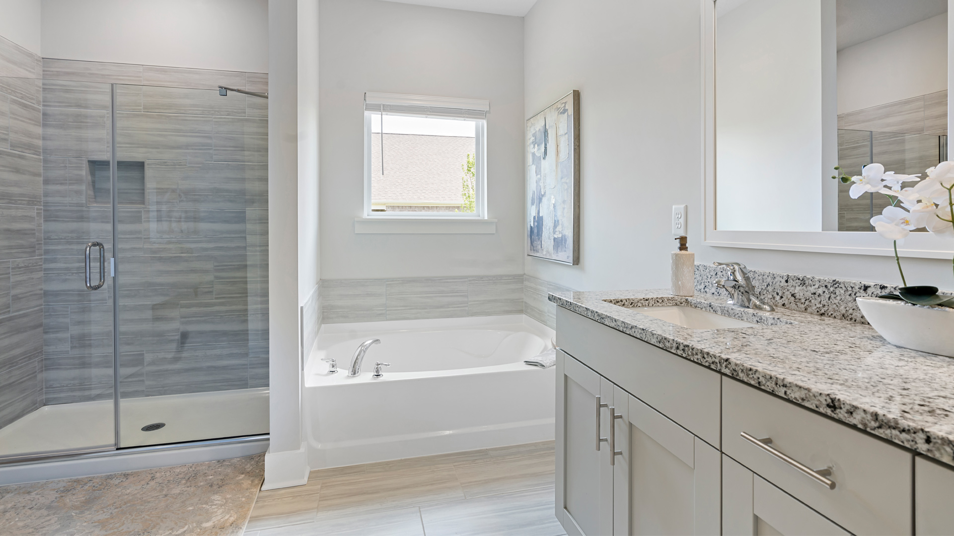 Primary en suite with a tub and a tile surround shower