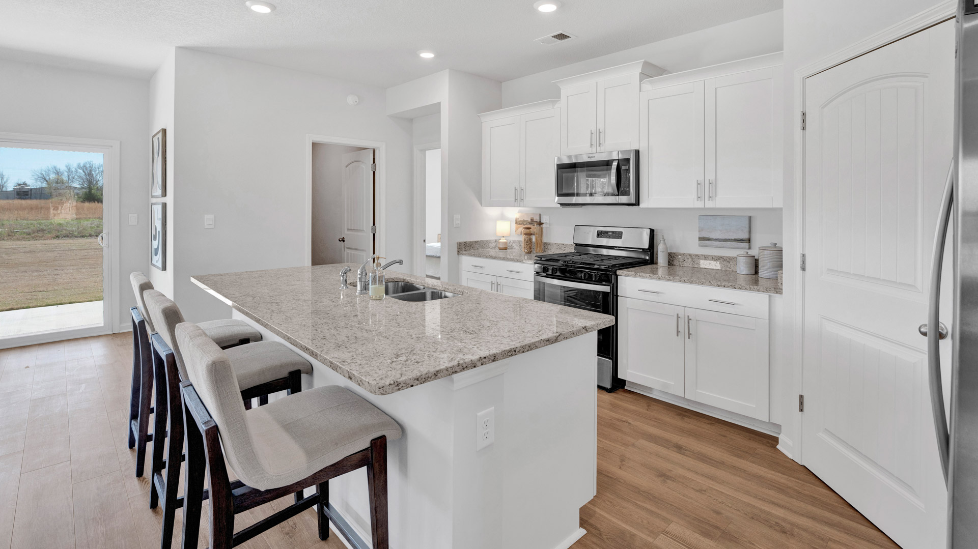Interior kitchen with white cabinets and granite countertops