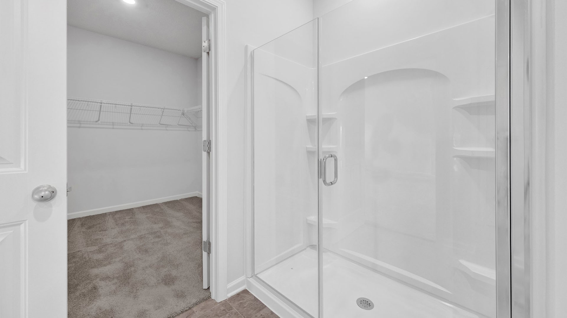 Glass enclosed walk in shower in the en suite