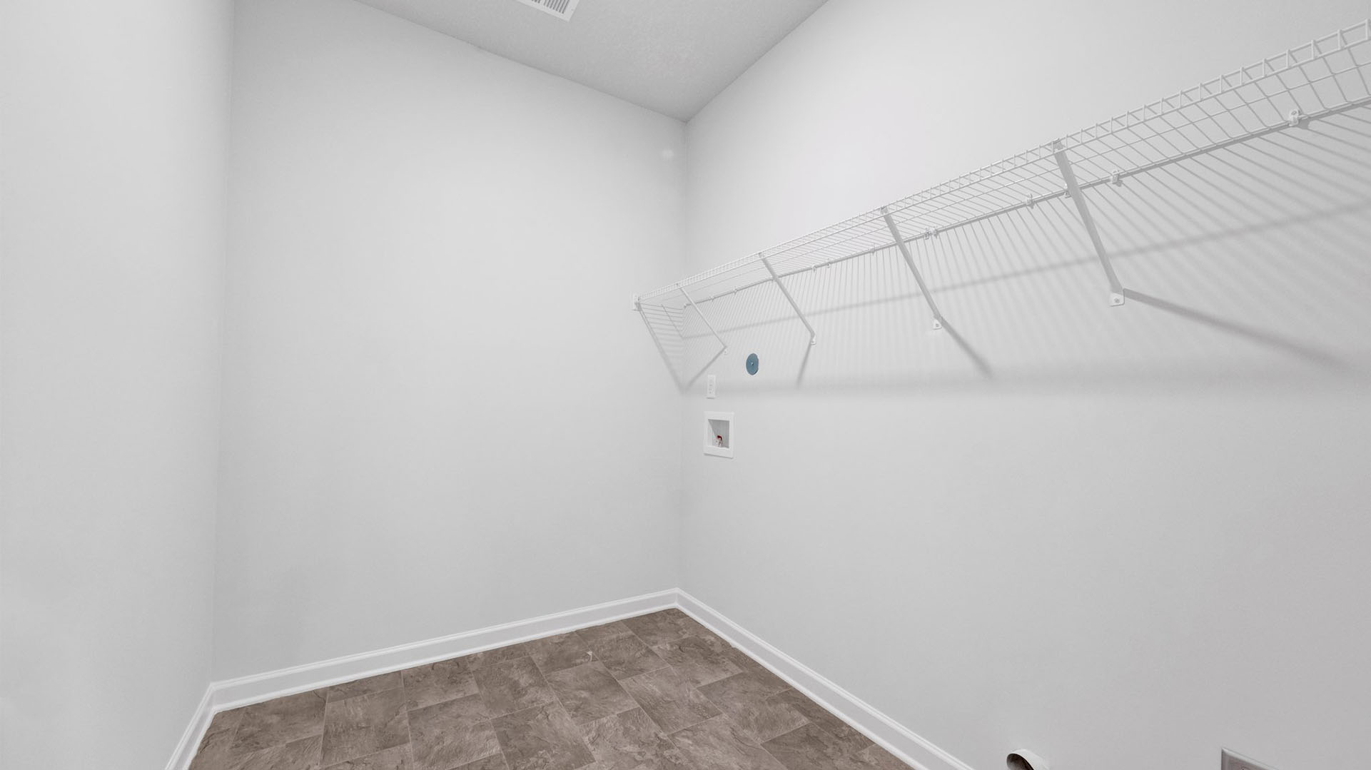 Spacious laundry room with ventilated shelving
