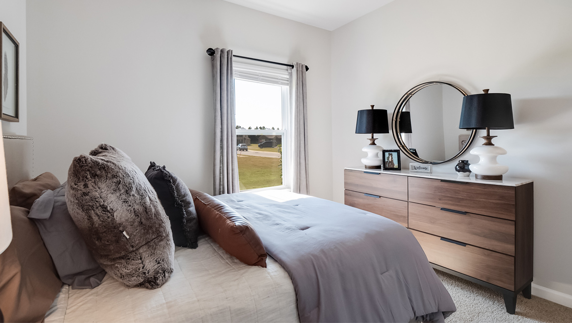 Second bedroom with neutral walls and carpet flooring