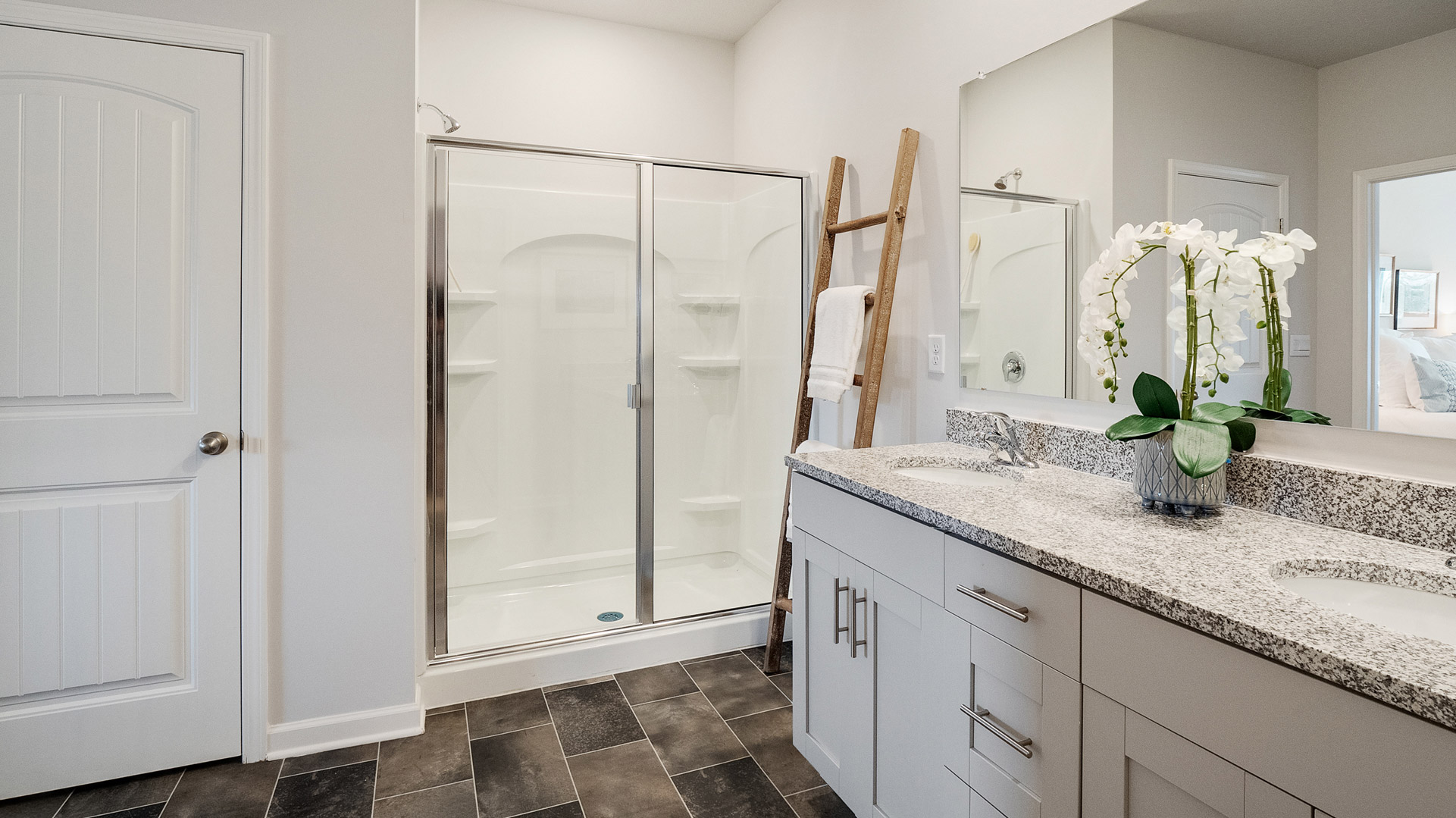 Owner’s bathroom showing dual sinks, bright finishes, and a spacious walk-in shower, closet at Villages at Southbranch