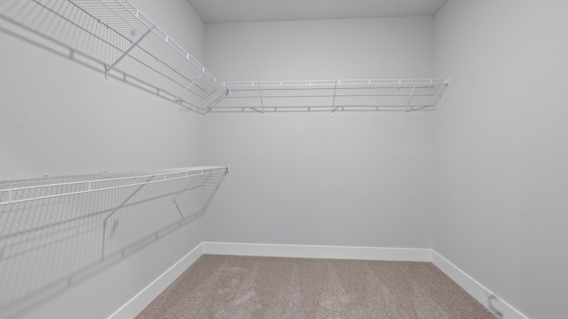 Primary walk-in closet with shelving, storage and drop zones at Villages at Southbranch
