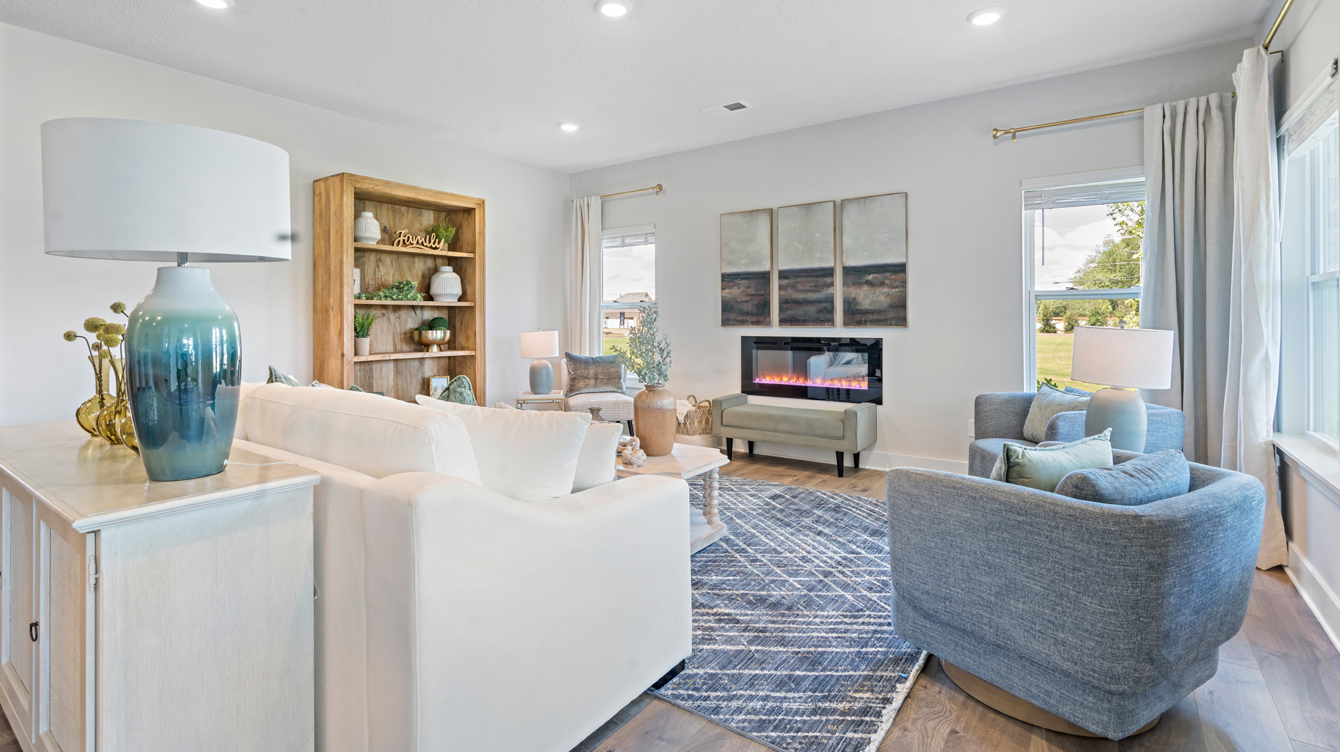 Living room with an open layout, modern finishes, and natural lighting at Villages at Southbranch