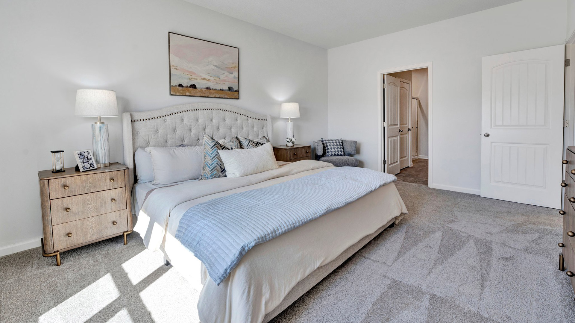 Spacious primary bedroom comfortably fits a king size bed and additional bedroom furniture