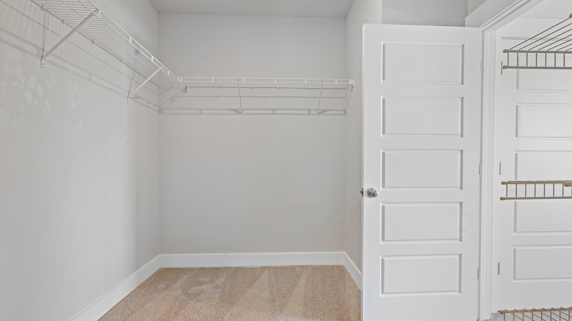Spacious primary closet with ventilated shelving