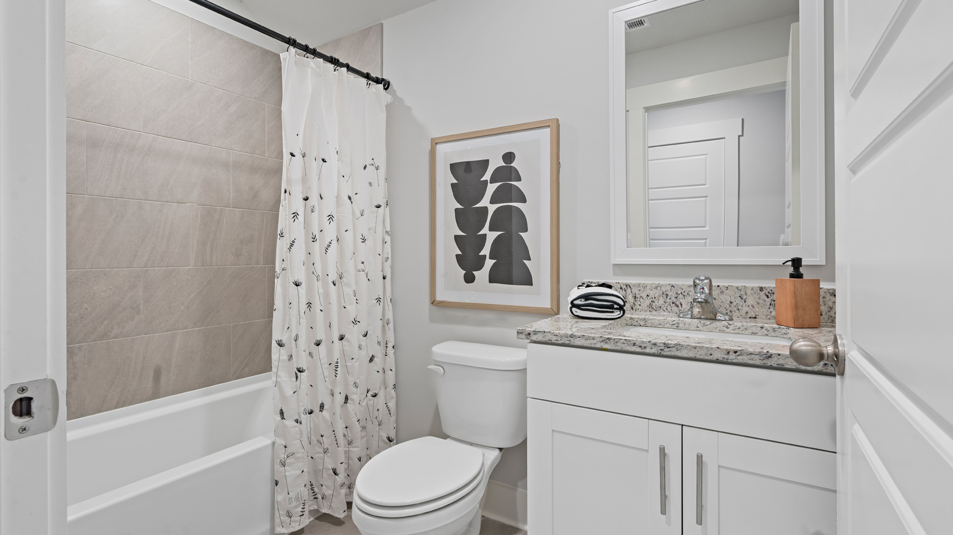 Guest bathroom on the second floor with a single vanity and an acrlyic tub/shower insert
