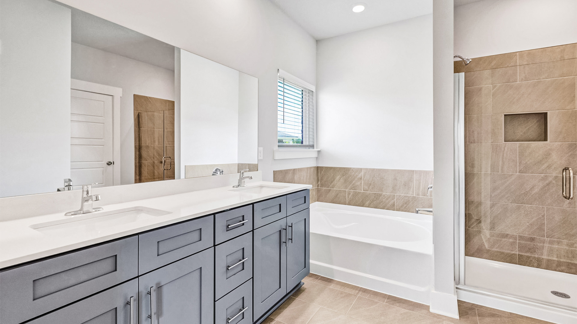 Primary en suite with a dual vanity and a tub and walk in shower
