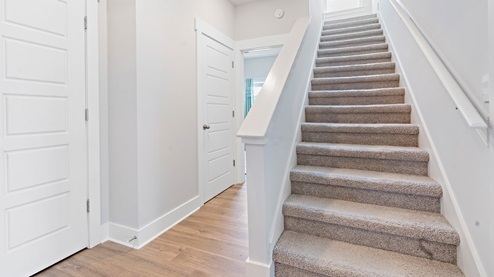 Stairways leading upstairs to the bonus room and fourth bedroom