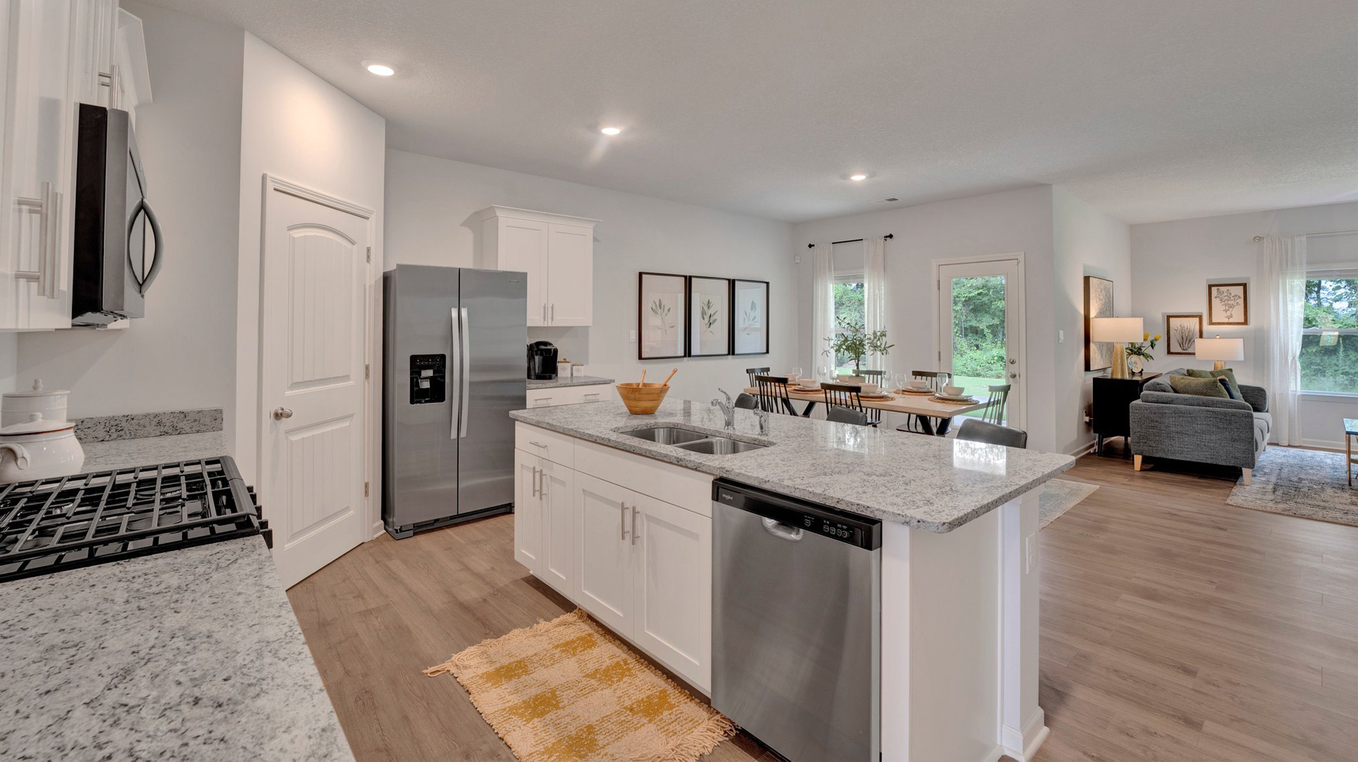 Kitchen area opens up at the end of entry hall