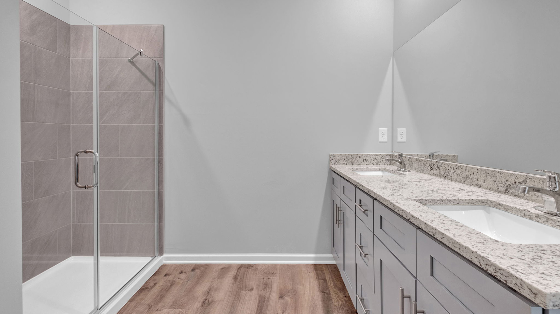 Primary bathroom with a granite countertop vanity