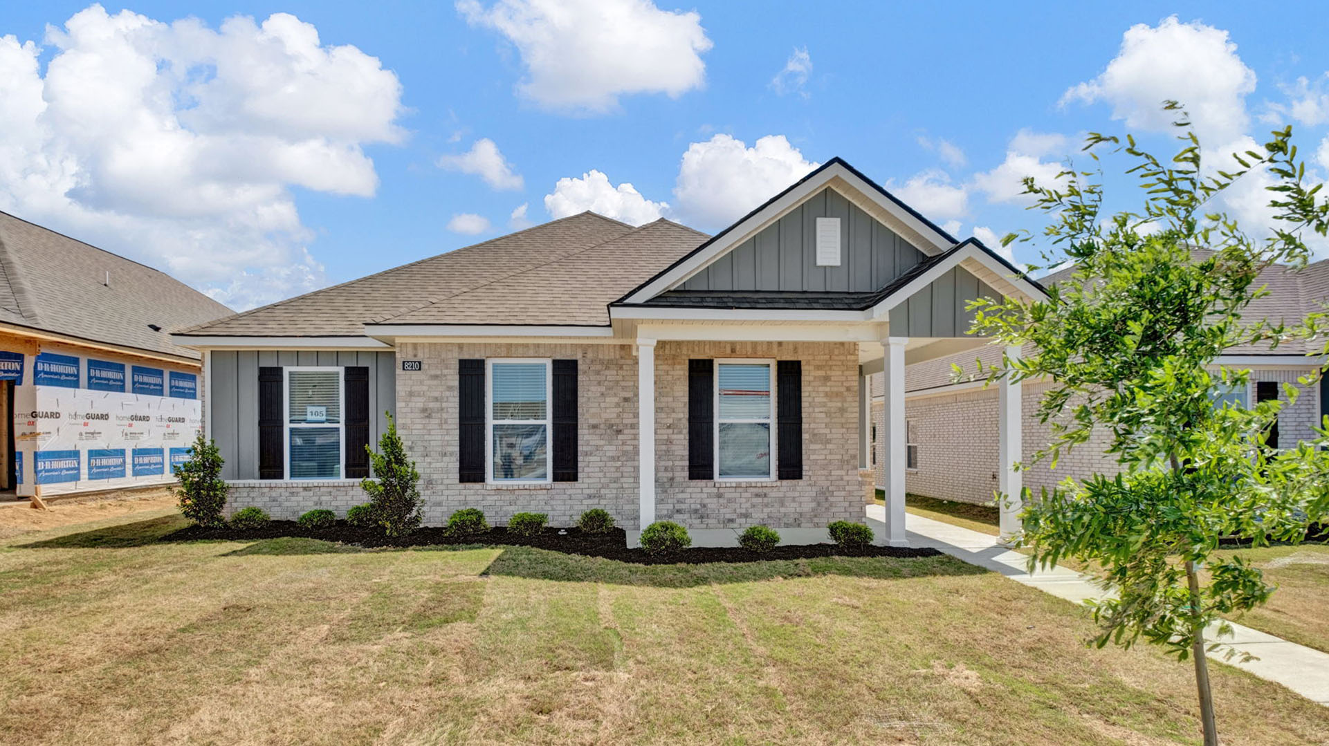 Exterior elevation of the Ardmore B24, a single story home with an alley load 2 car garage