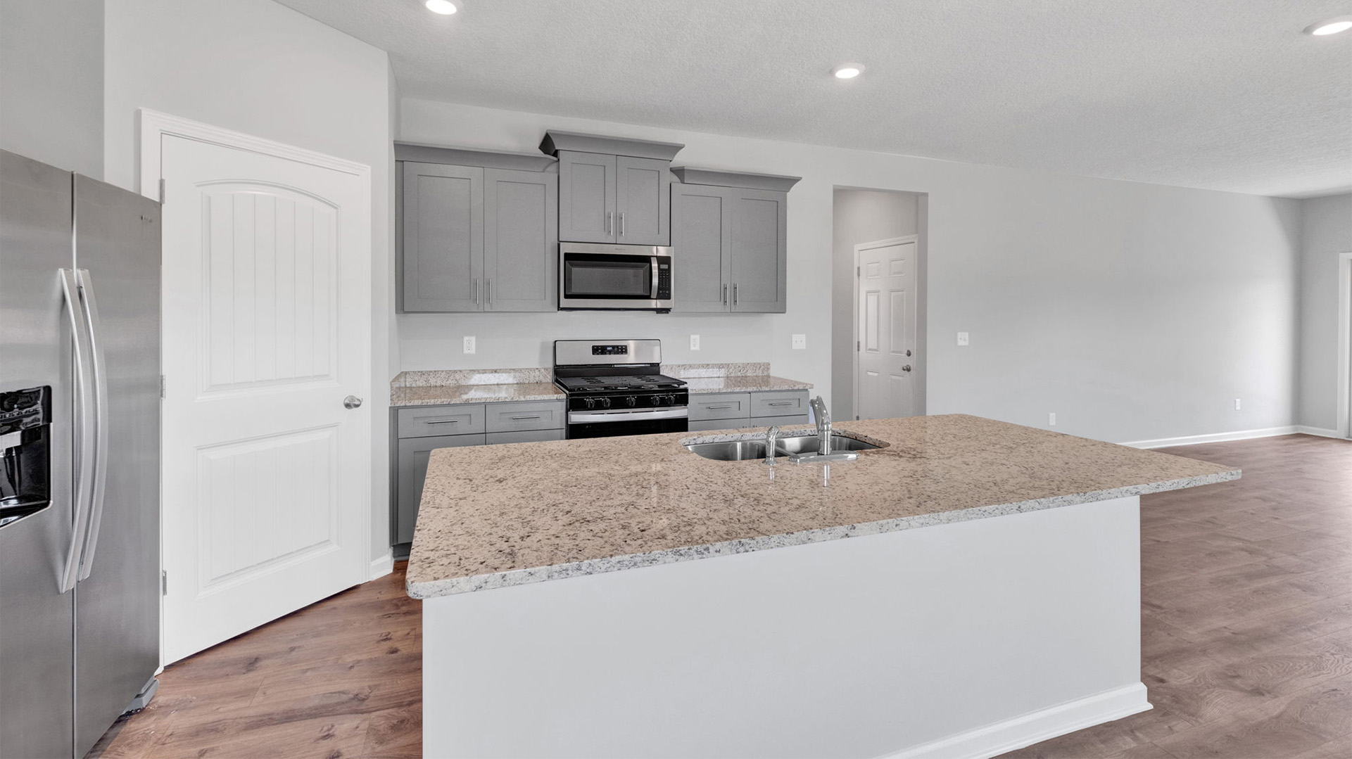 Beautiful kitchen area opens up at the end of entry hall