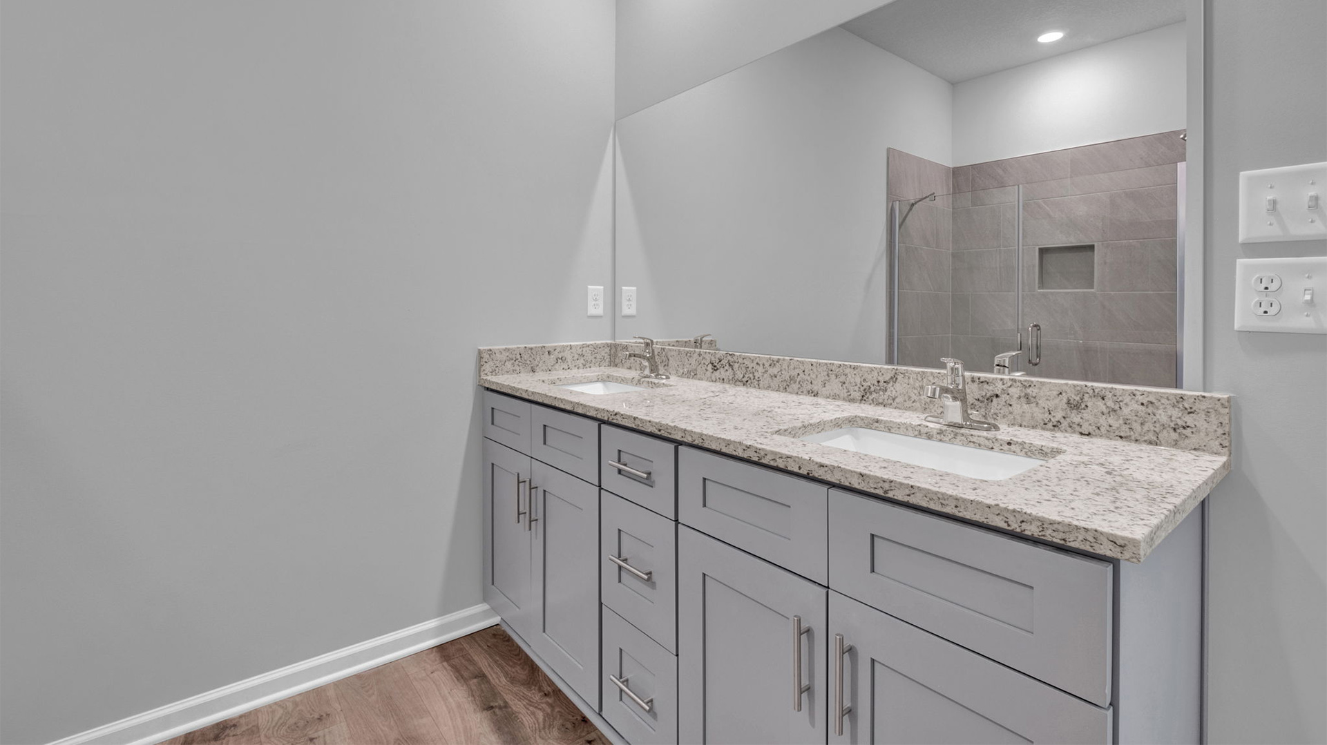 EN suite primary bathroom with granite counter top vanity